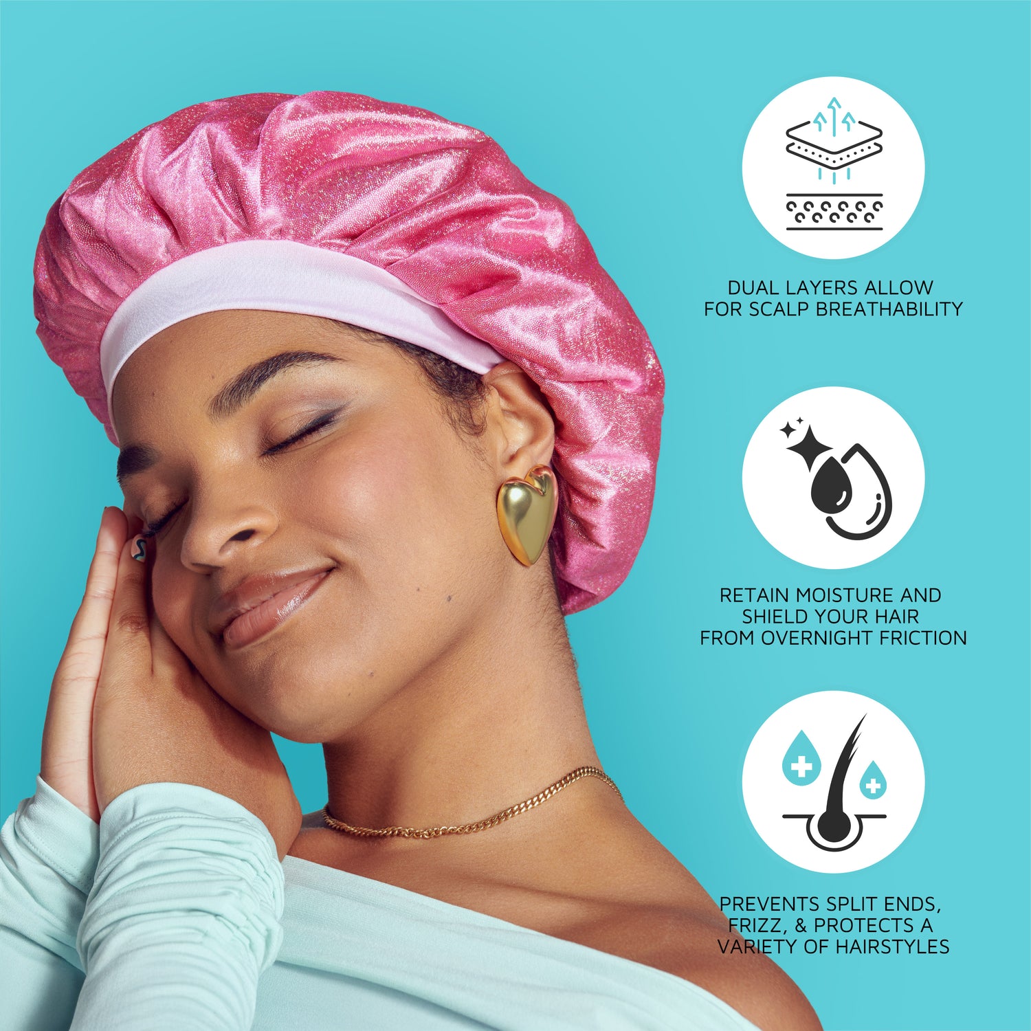Woman with closed eyes wearing a shiny pink satin bonnet cap, gold heart earrings, and mint top on blue background. Text highlights breathability, moisture retention, and protection against split ends and frizz.