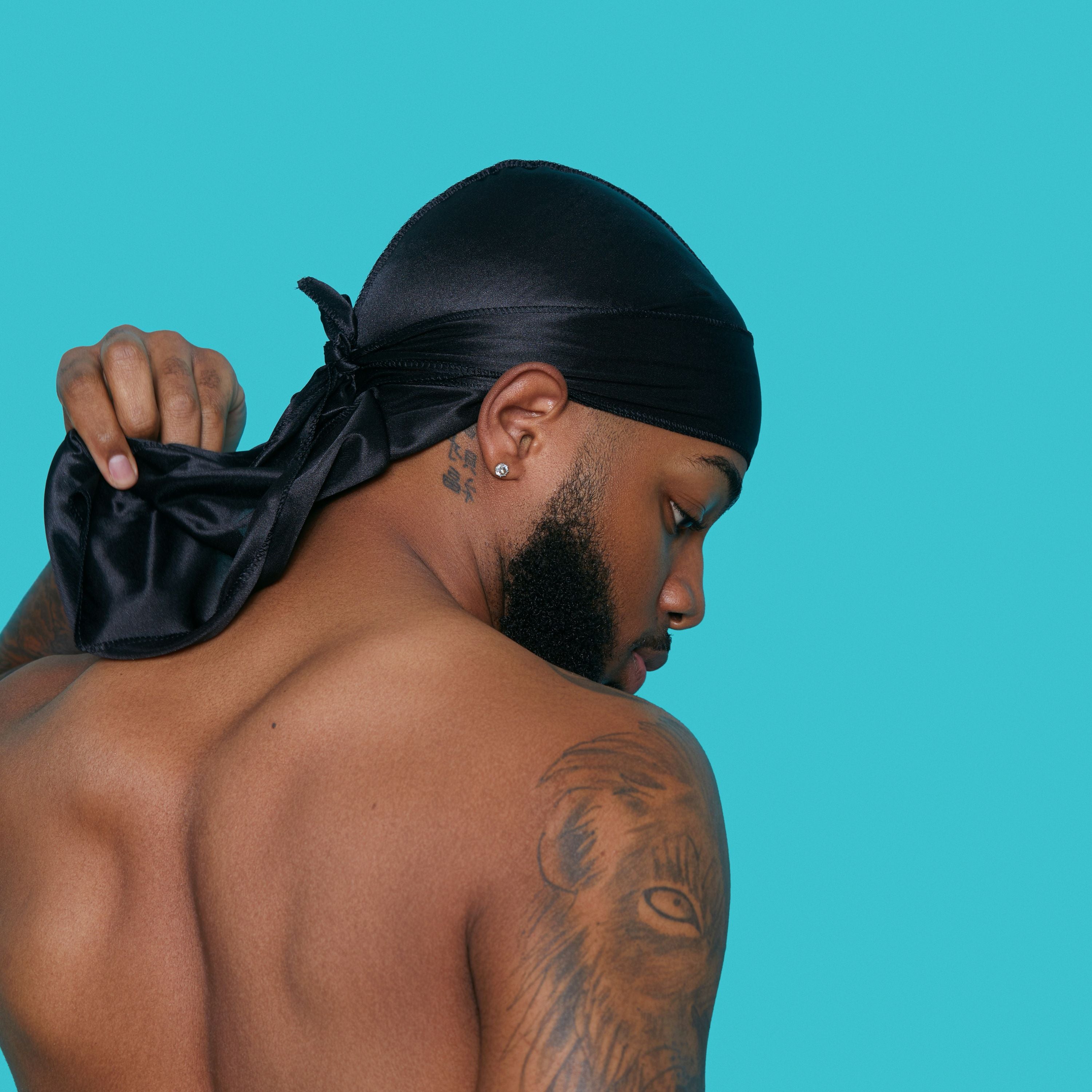 Black silky satin durag tied on a man&