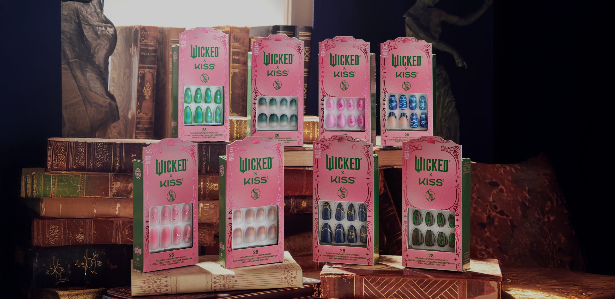Eight Wicked Kiss nail polish boxes displayed on vintage books against dark backdrop.