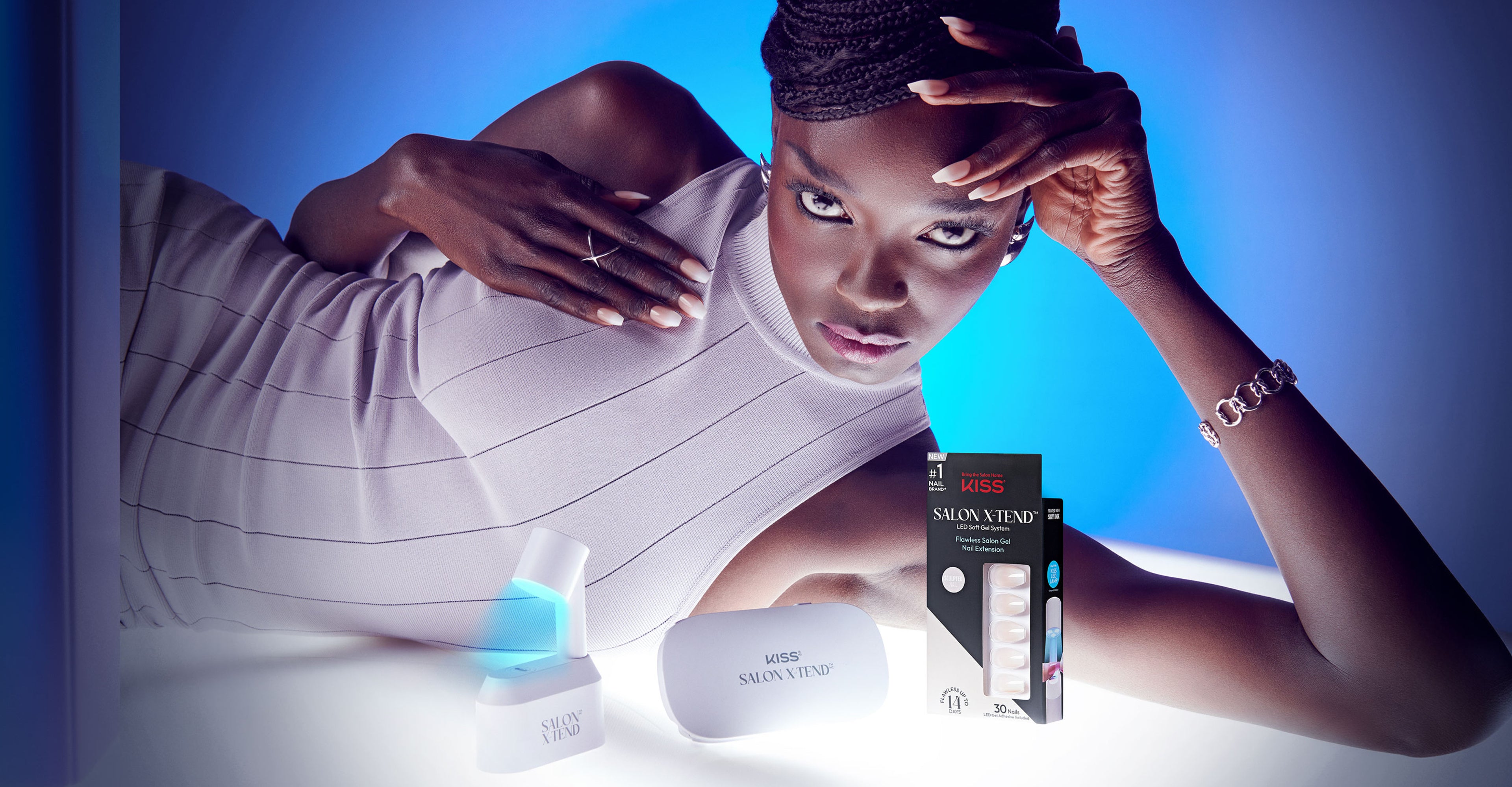 Kiss Salon X Tend nail extension product with model displaying manicure against blue background.