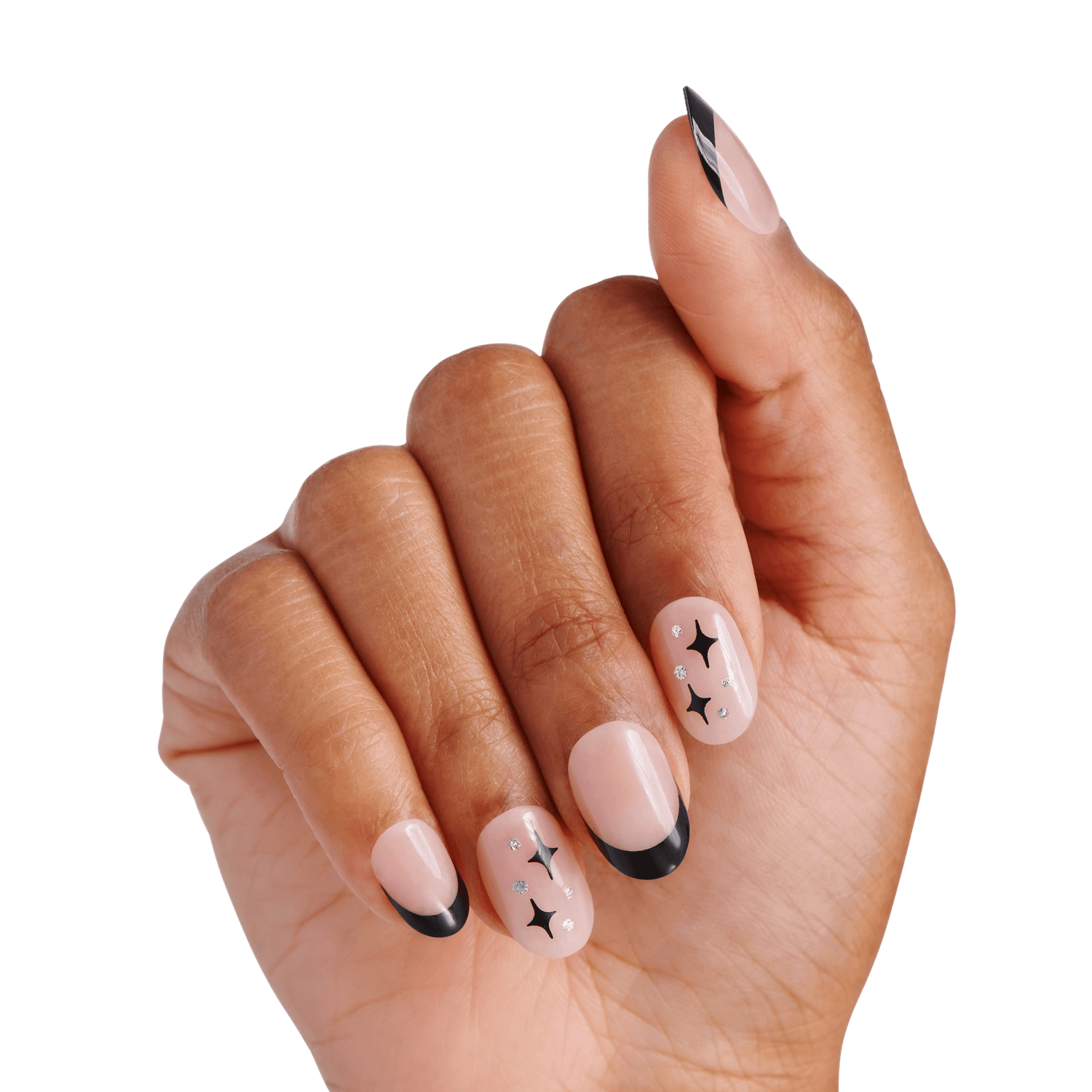 The image features a hand with elegantly manicured nails. The nails are painted in a soft nude shade, complemented by a stylish black French tip. Additionally, there are decorative elements, including small black stars and dots, adding a playful and artistic touch to the overall design. The hand is positioned in a way that showcases the nails prominently against a clean, white background.