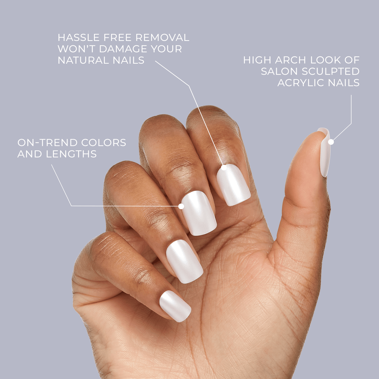 Hand with medium brown skin tone wearing pearly white press-on nails against a pale lavender background. Text highlights hassle-free removal that won’t damage natural nails, on-trend colors and lengths, and high arch look of salon-sculpted acrylic nails.