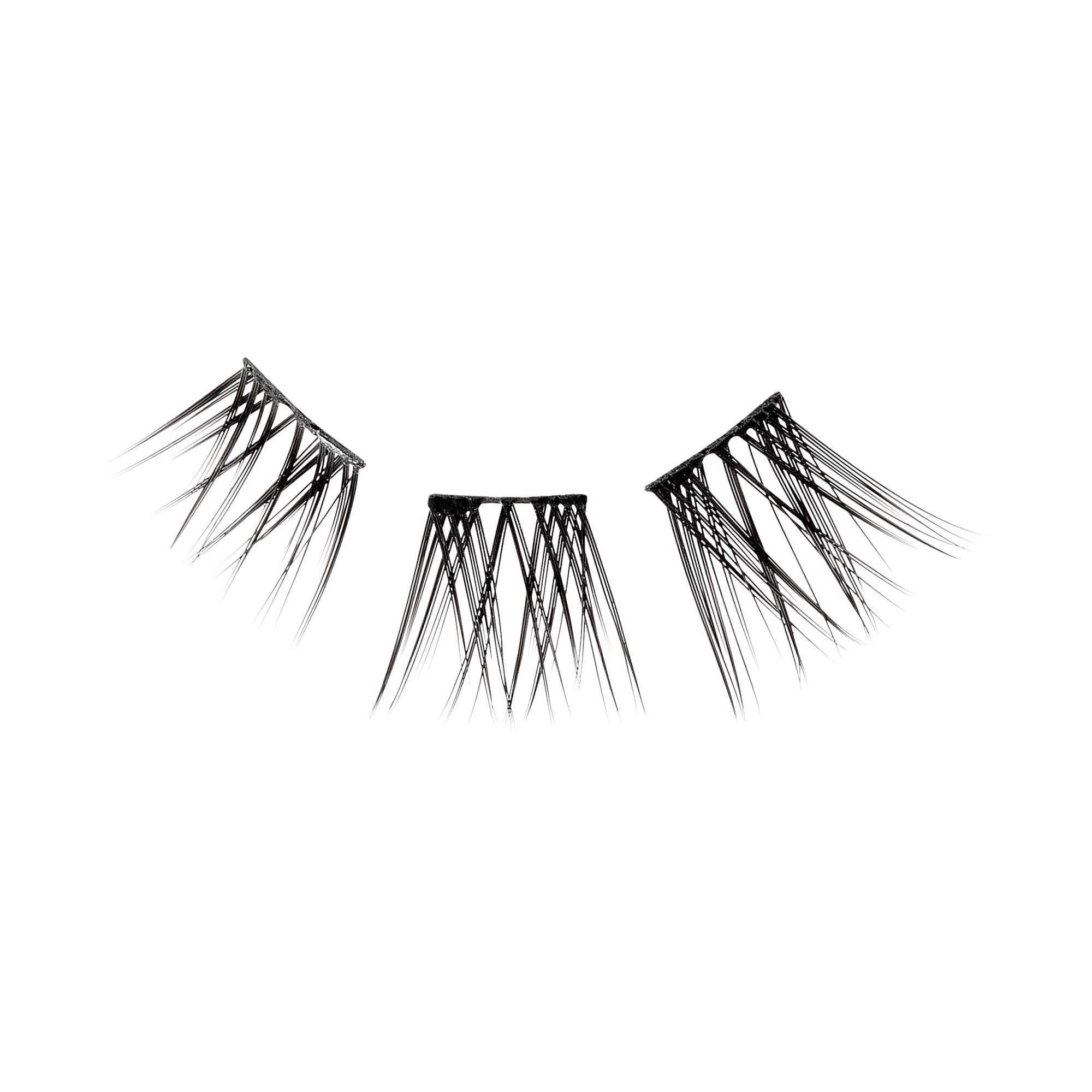 The image shows a pair of false eyelashes. The eyelashes are black and have a dramatic, spiky design with varying lengths of lashes. They are arranged in a semi-circular shape, typical of false eyelashes, and are designed to be applied to the upper eyelid to enhance the appearance of natural lashes. The lashes are separated into three distinct sections, likely for easier application and a more customizable fit.