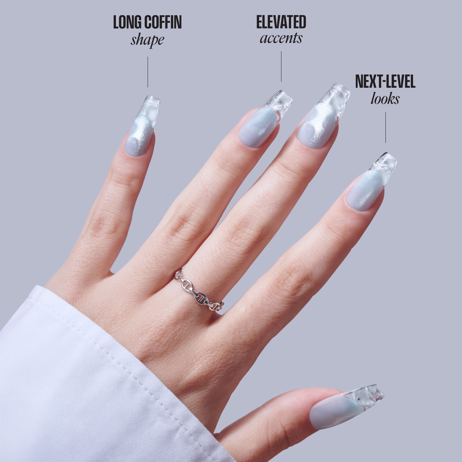 Silver glitter coffin nails with elevated accents and next-level designs on model hand.