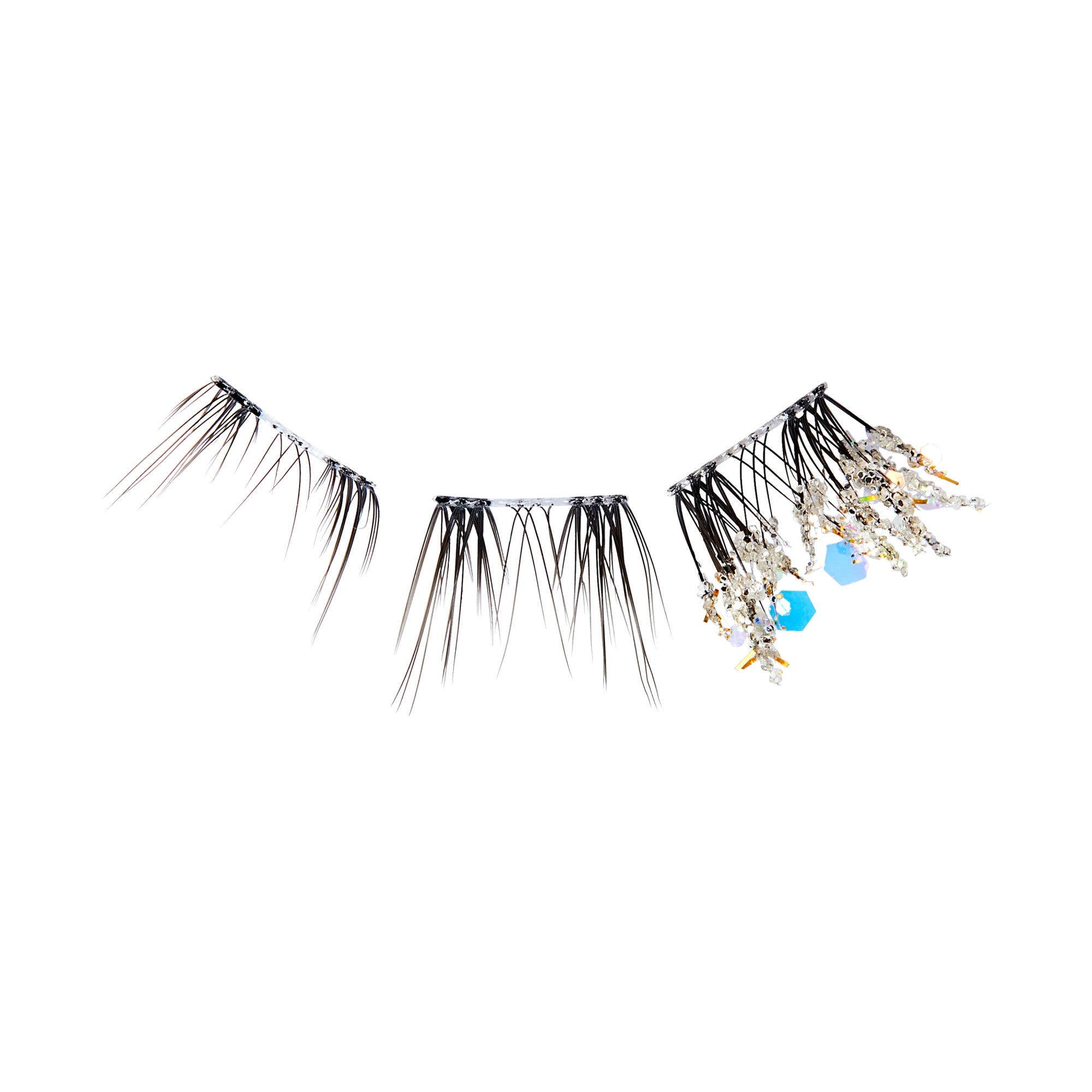 The image features a set of decorative hair accessories. There are three distinct pieces, each adorned with various embellishments. The first two pieces consist of long, slender strands that resemble hair, while the third piece is more ornate, featuring beads and crystals in shades of blue and clear. The overall design suggests a stylish and artistic approach to hair adornment, suitable for special occasions or fashion-forward looks.