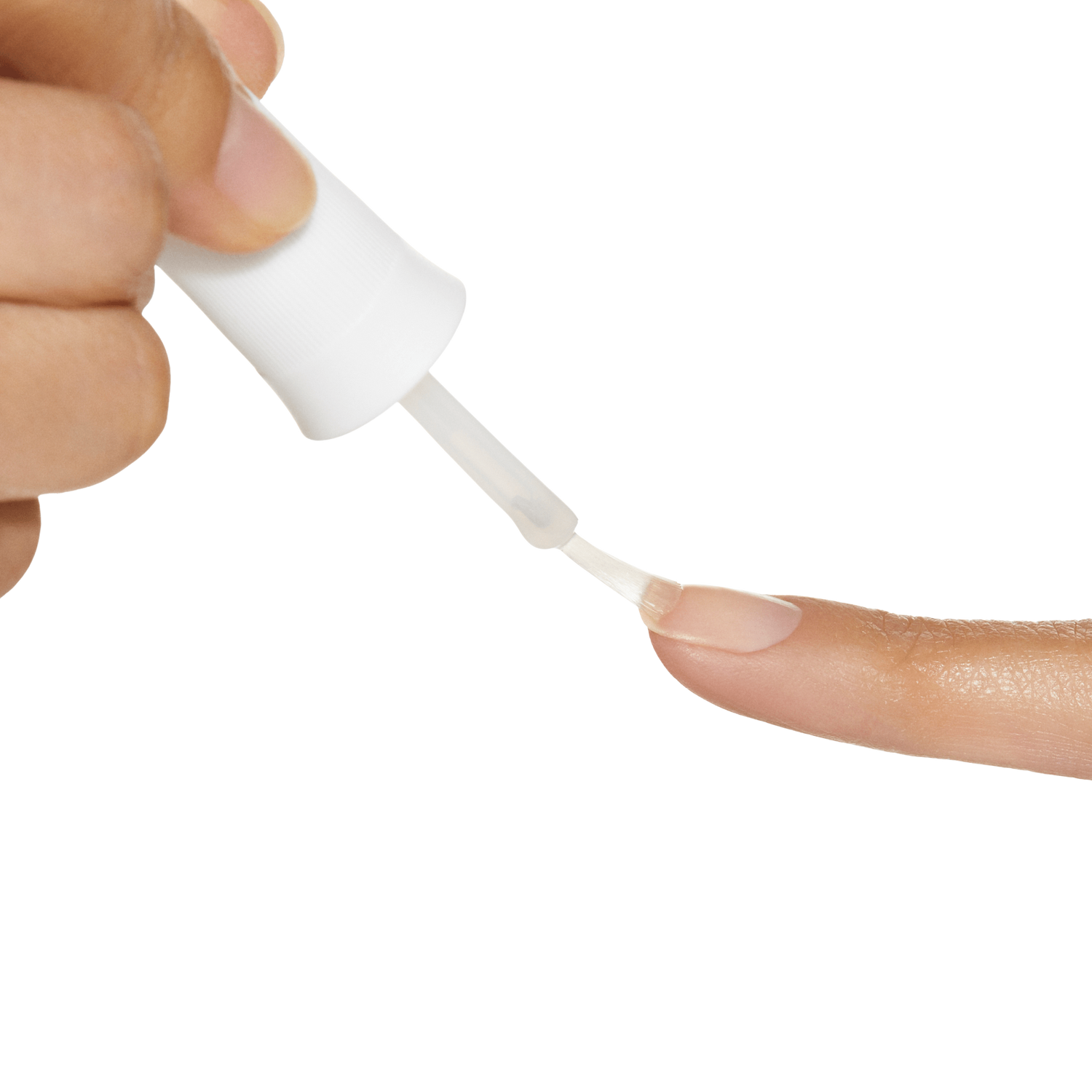 Hand holding a white brush-on applicator applying clear nail glue onto the tip of a natural fingernail, shown against a black background.