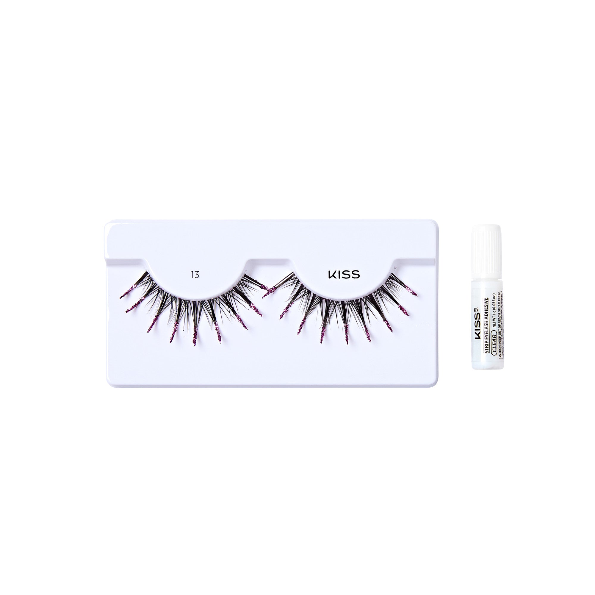 The image shows a set of false eyelashes from the brand "KISS." The eyelashes are displayed on a white tray with the number "13" marked on it. The lashes are long and have a dramatic, spiky design with some red accents. To the right of the tray, there is a small tube of adhesive glue for applying the eyelashes. The overall presentation is clean and minimalistic, highlighting the product.