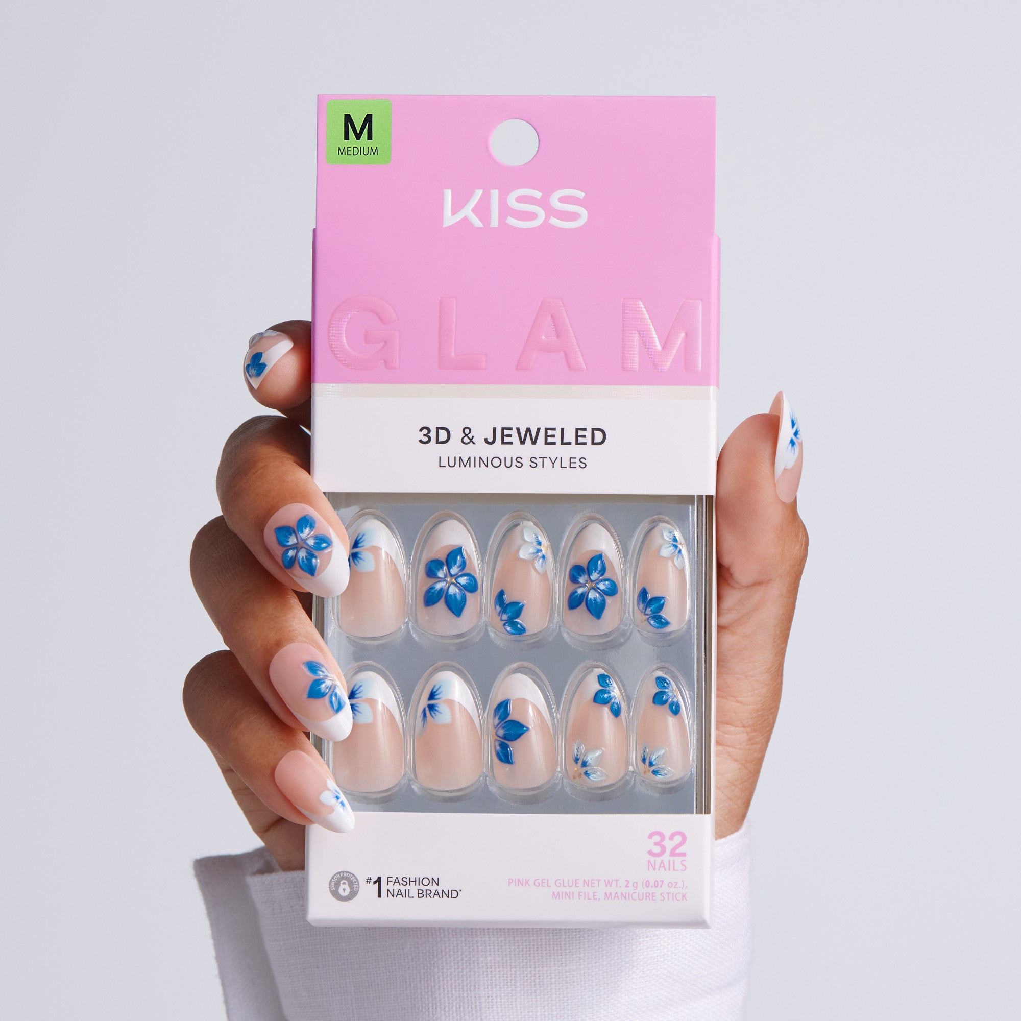 Kiss Glam 3D &amp; Jeweled nail packaging held by a hand with matching nail designs.