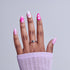Hand displaying pink nail art designs with swirl patterns on white and bright pink nails.