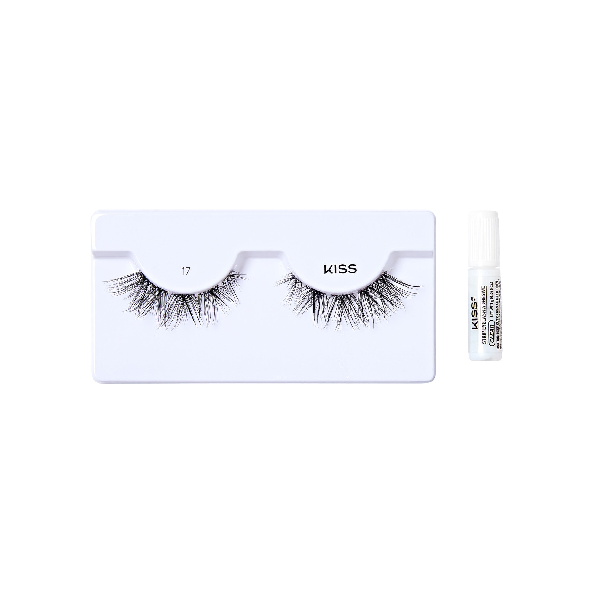 The image shows a set of false eyelashes from the brand "KISS." The eyelashes are displayed on a white plastic tray, with the number "17" printed on the left side of the tray. To the right of the tray, there is a small tube of adhesive glue, also branded with "KISS." The eyelashes appear to be voluminous and have a natural, wispy look.
