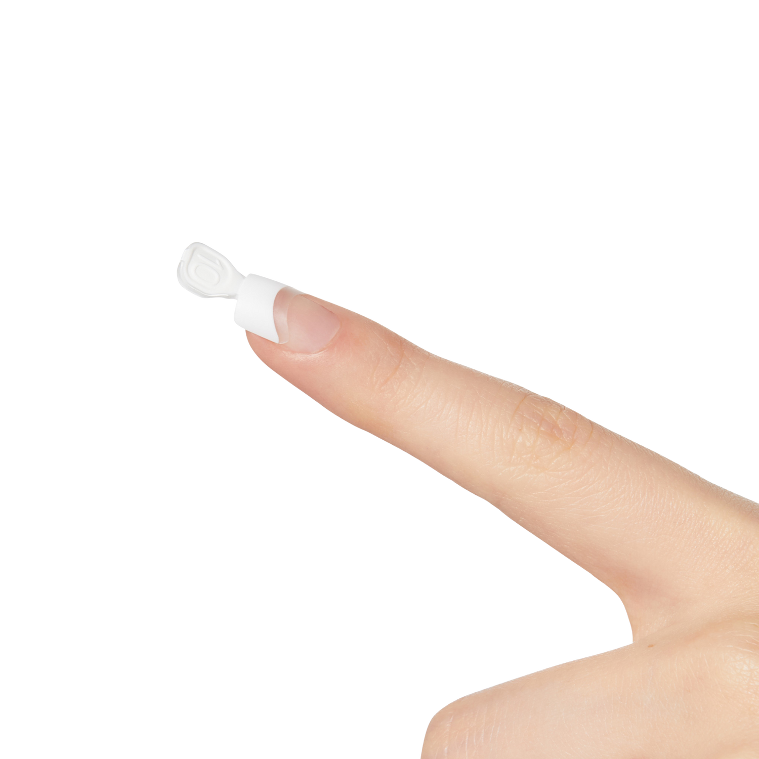 Close-up of a finger with a white plastic nail shield from the KS Brush-On Gel Nail Kit applied on the nail, showing the shield&