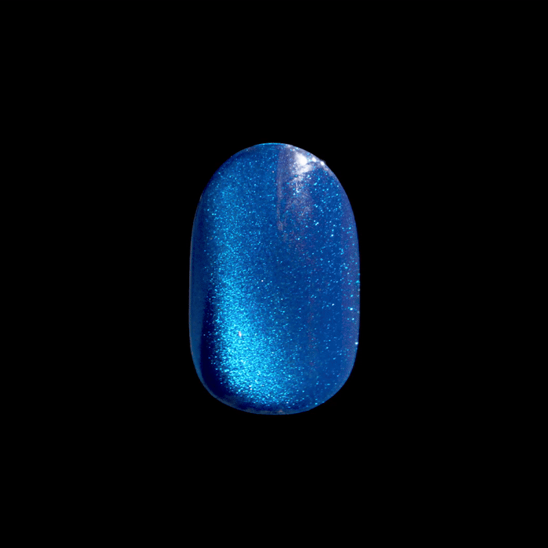 Shiny press-on nail in vibrant metallic blue with fine glitter sparkle, shown against a black background.