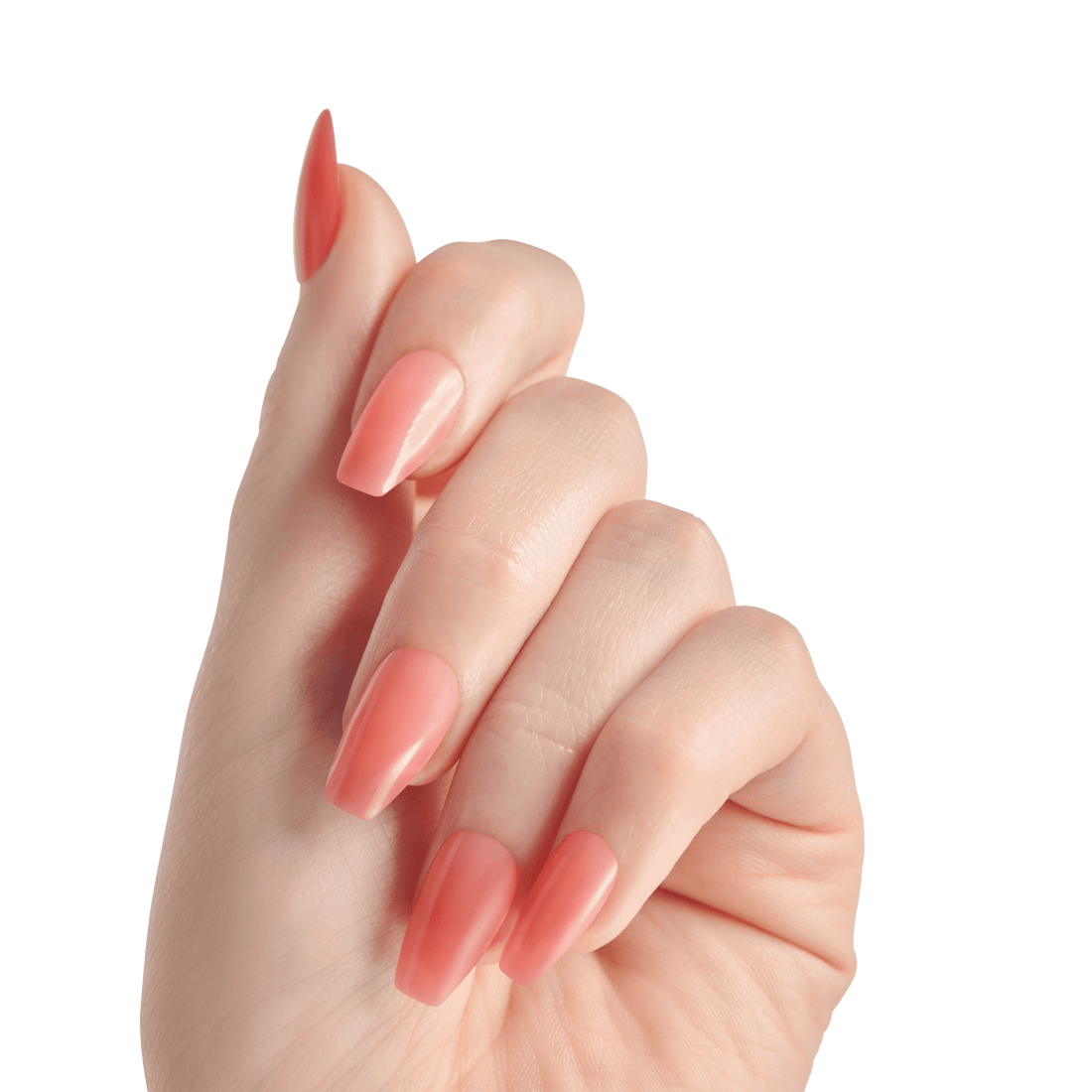The image features a hand with well-manicured nails painted in a soft coral or peach shade. The nails are long and have a glossy finish, showcasing a stylish and elegant appearance. The hand is positioned with fingers slightly curled, emphasizing the nails. The background is plain white, which highlights the color and shape of the nails.