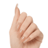 Hand showing long, coffin-shaped press-on gel nails in a glossy nude shade, with a smooth, polished finish and no visible on-image text.