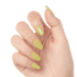 Hand with medium-length, matte pale yellow press-on gel nails shaped in a rounded square, shown against a white background.