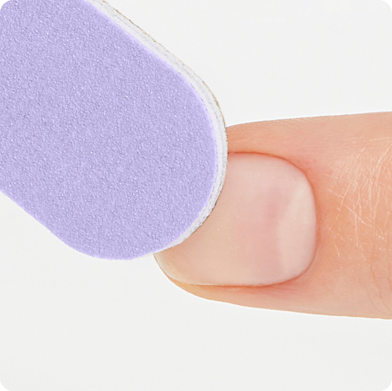 Purple nail file being held against a natural nail, demonstrating filing technique.
