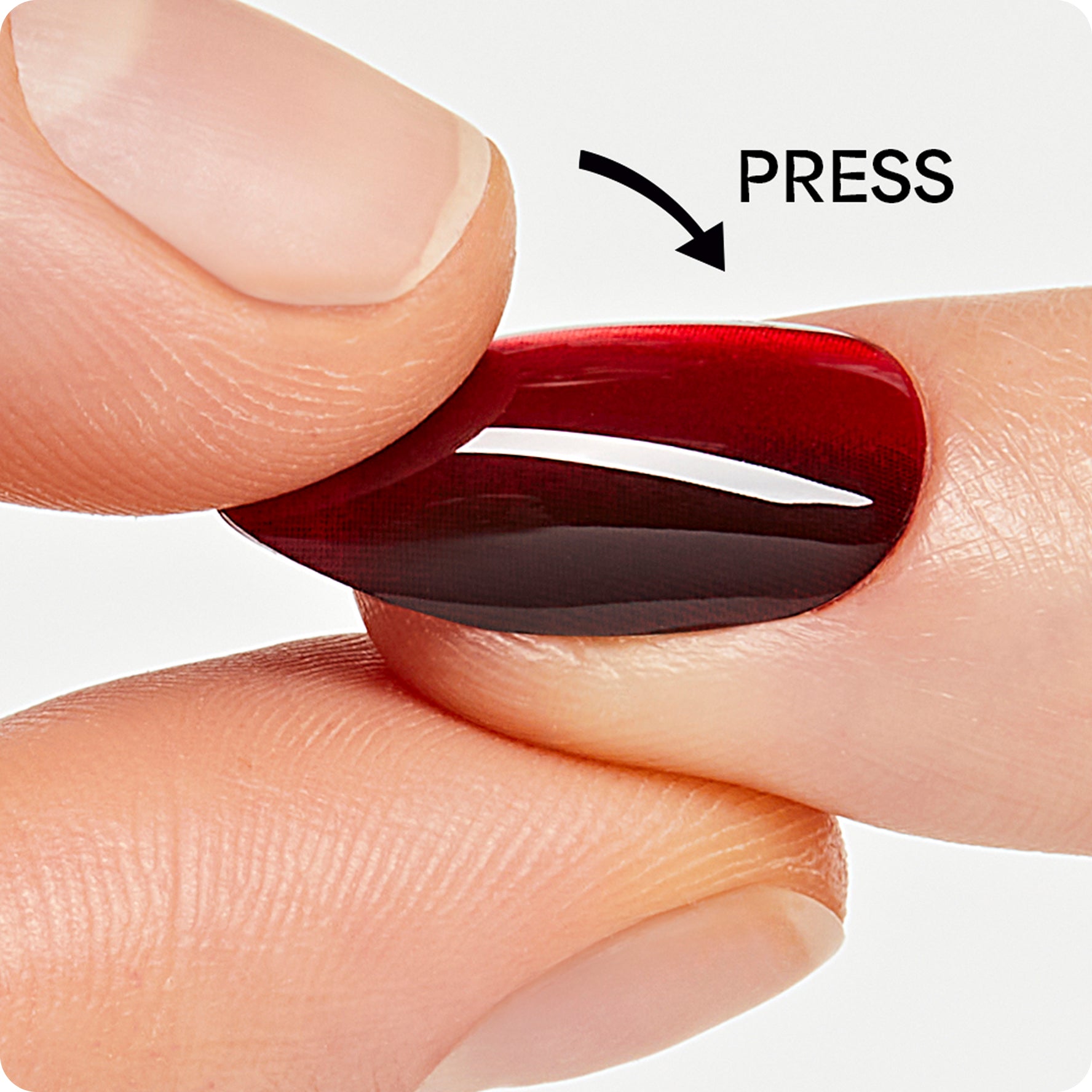 Press-on nail demonstration showing application technique with red manicure.