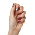 The image shows a close-up of a hand with long, almond-shaped nails. The nails are painted in a glossy, deep burgundy color. The hand is positioned with the fingers slightly curled inward, and the skin tone is light. The overall appearance is neat and well-manicured.
