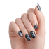 The image features a hand with elegantly manicured nails showcasing a cosmic-themed nail art design. The nails are primarily painted in a deep black color, resembling a night sky, with various artistic elements. Some nails have a glossy finish, while others display a matte texture. There are accents of silver and white, including stars and a crescent moon, adding to the celestial theme. The overall look is stylish and modern, perfect for someone who enjoys unique and artistic nail designs.