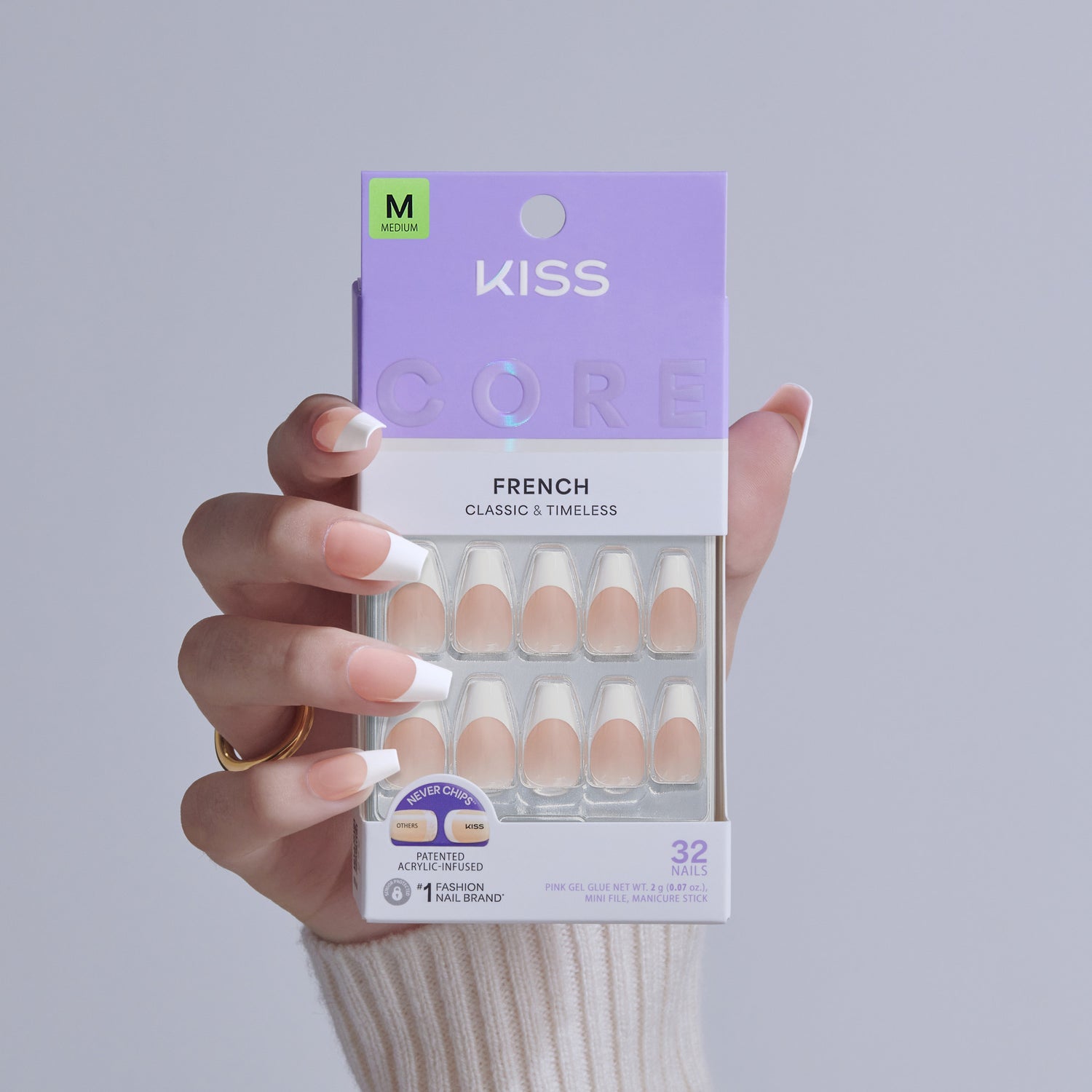 KISS Core French Classic &amp; Timeless Medium Fake Nails in packaging held by hand