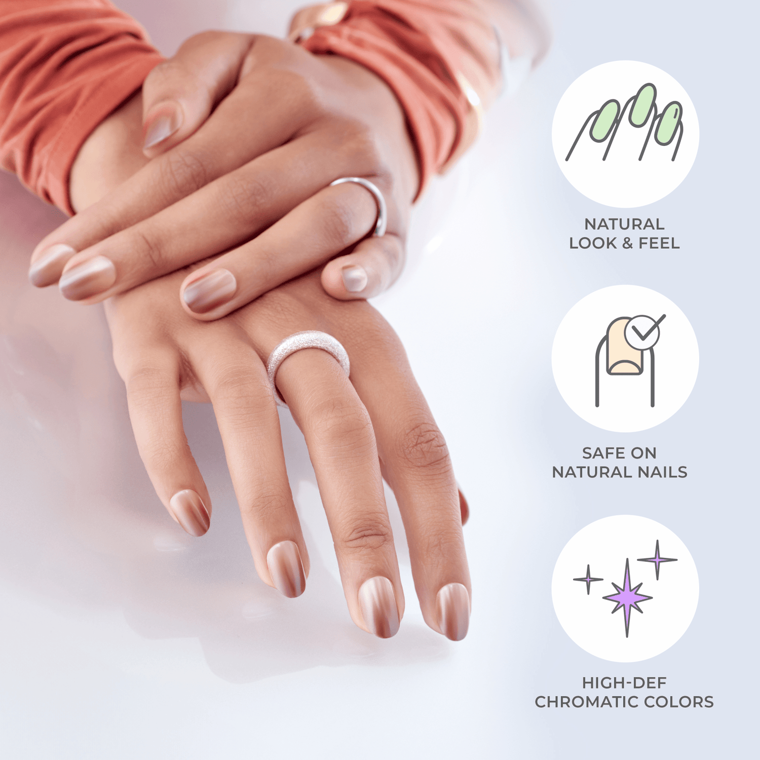 Two hands with press-on nails in a soft, natural beige with a satin finish, featuring rings on fingers; text highlights natural look, safety on nails, and vibrant colors.