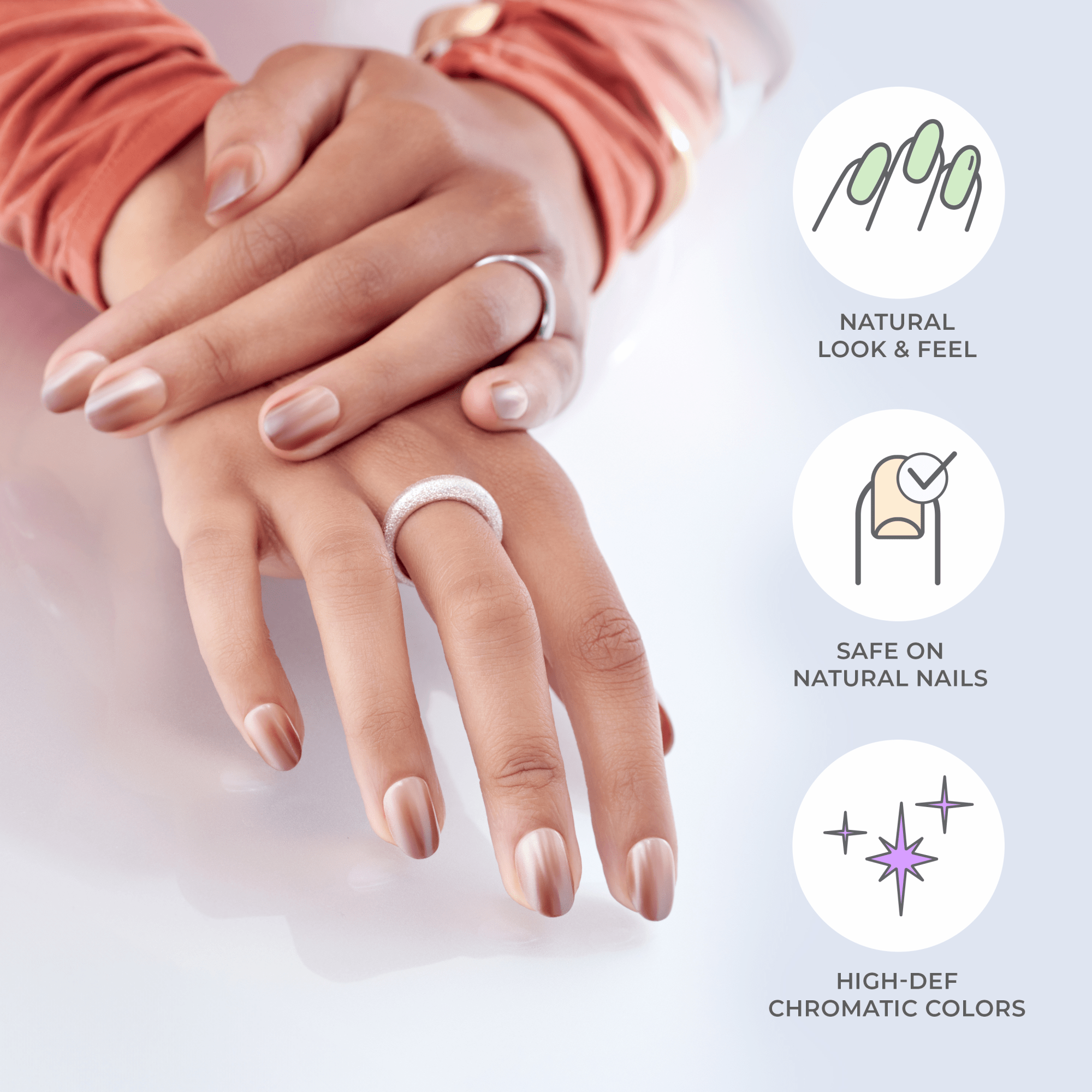Two hands with press-on nails in a soft, natural beige with a satin finish, featuring rings on fingers; text highlights natural look, safety on nails, and vibrant colors.