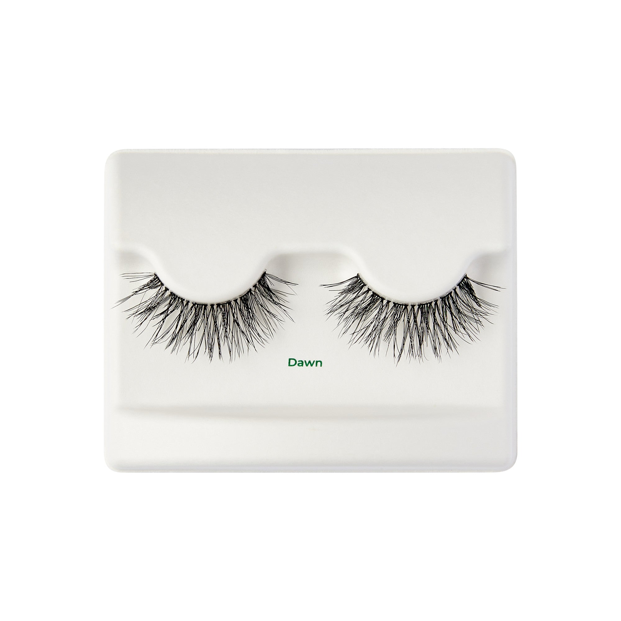 The image shows a pair of false eyelashes displayed on a white plastic tray. The eyelashes are thick and voluminous, with a wispy, natural look. The tray has two indentations where the eyelashes are placed, and the word "Dawn" is printed in small green text below the eyelashes. The overall presentation is clean and minimalistic.