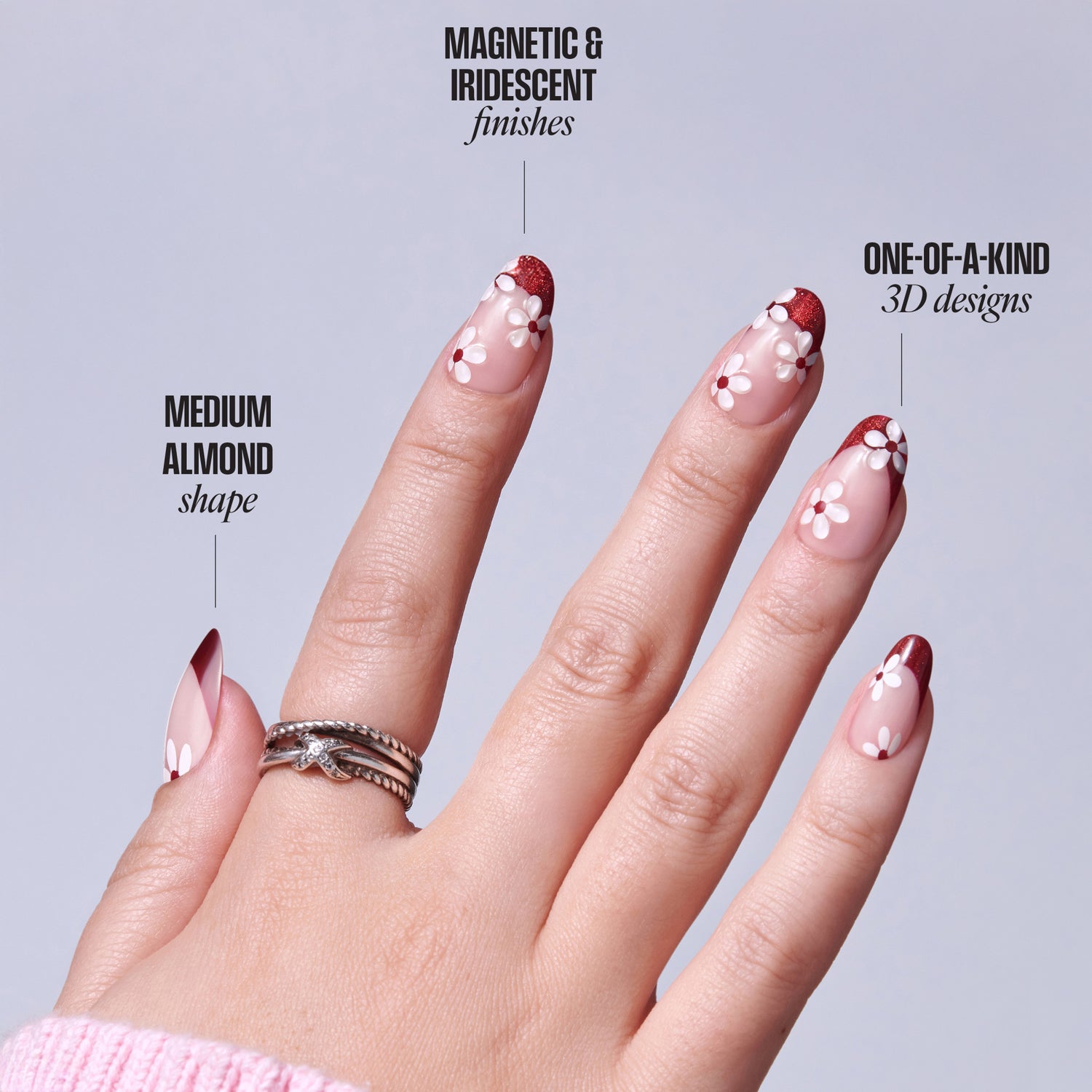 Almond-shaped nails with red and white 3D floral designs, magnetic iridescent finish.