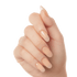 Close-up of a hand showing long, almond-shaped press-on gel nails in a glossy nude peach shade called Moonlight.