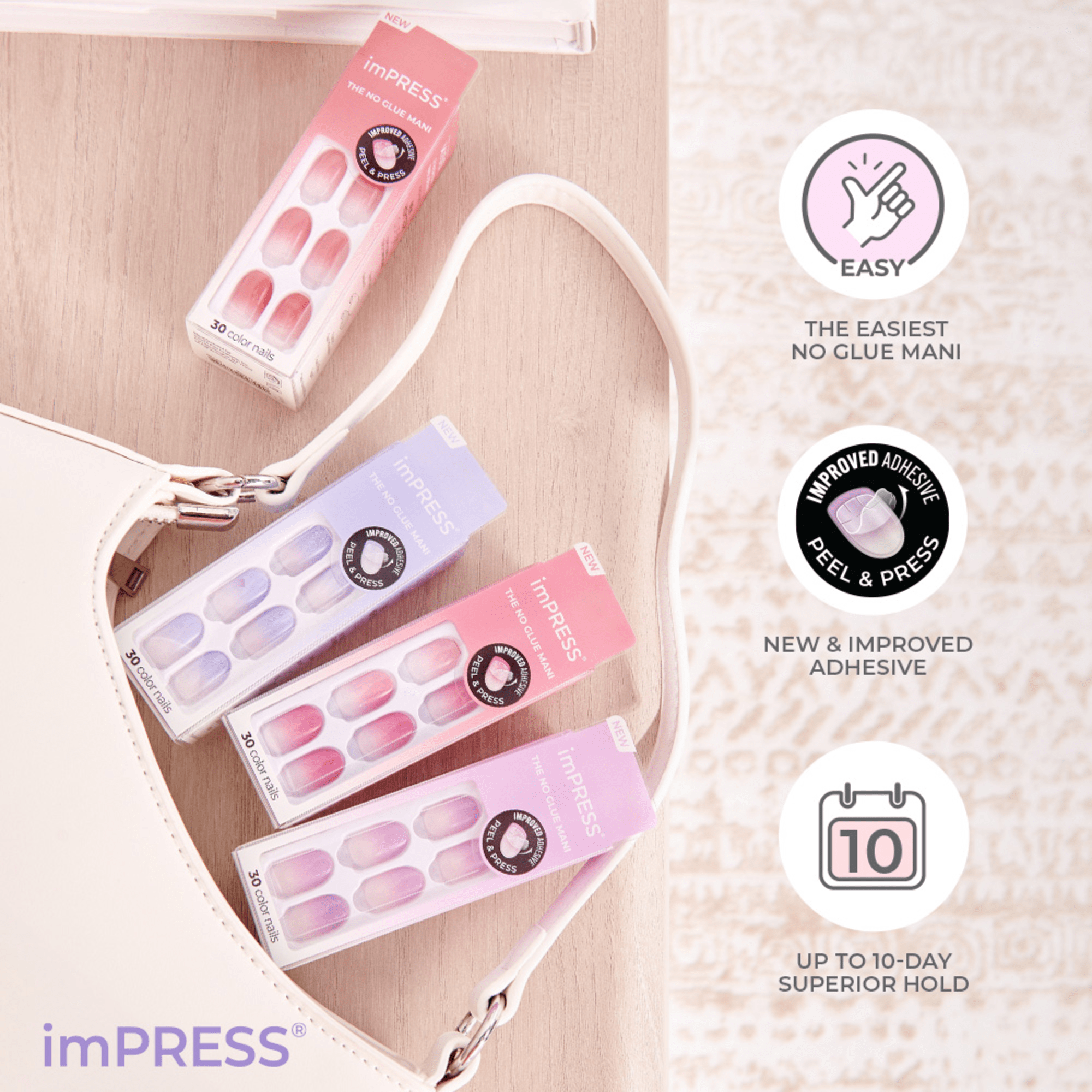 Four packages of imPRESS Color Press On Nails in shades of pink and lavender, displayed inside and near a beige purse, with text highlighting easy no-glue application, new improved adhesive, and up to 10-day hold.