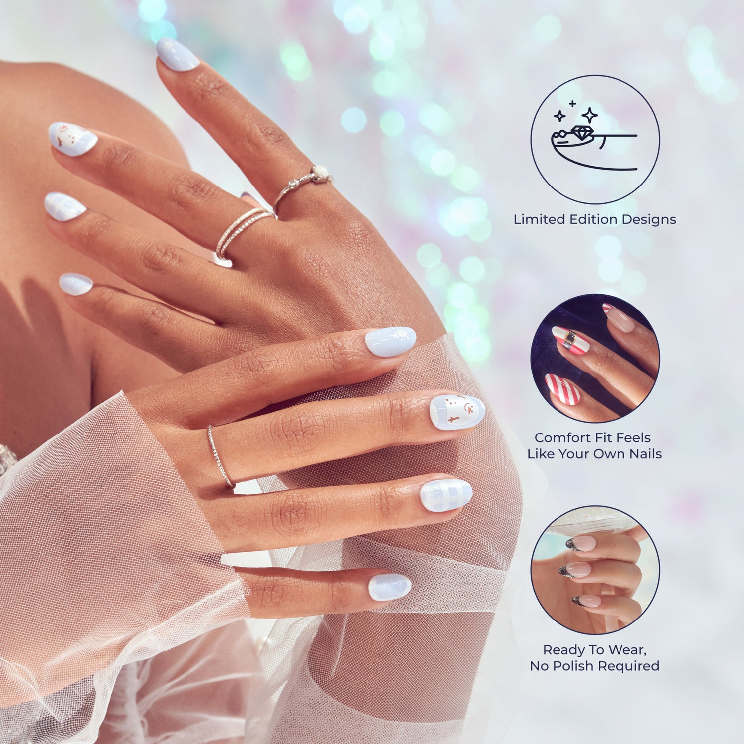 Hands with light blue and white holiday-themed press-on nails featuring snowmen and checkered designs, wearing delicate silver rings. Text highlights limited edition designs, comfort fit like natural nails, and no polish required.