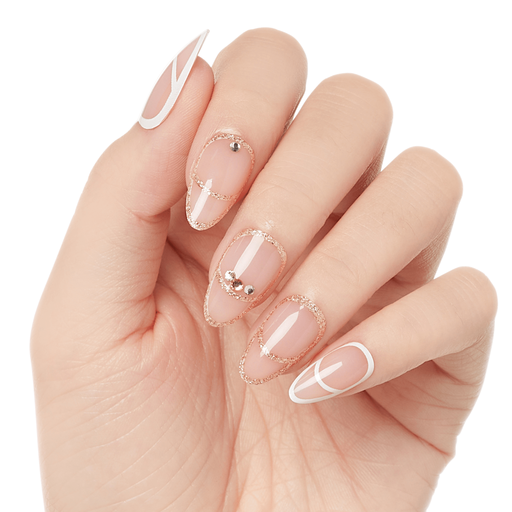 Hand with long, almond-shaped press-on nails in translucent nude, decorated with rose gold glitter outlines, small rhinestones, and white geometric lines.