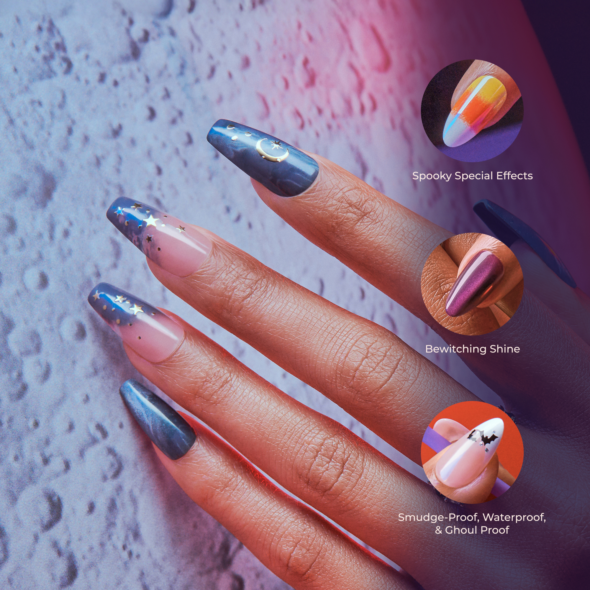 Hand with long press-on nails featuring Halloween-themed designs: dark blue with gold stars and crescent moon, pink ombre with stars, metallic purple, and light pink with black bats.