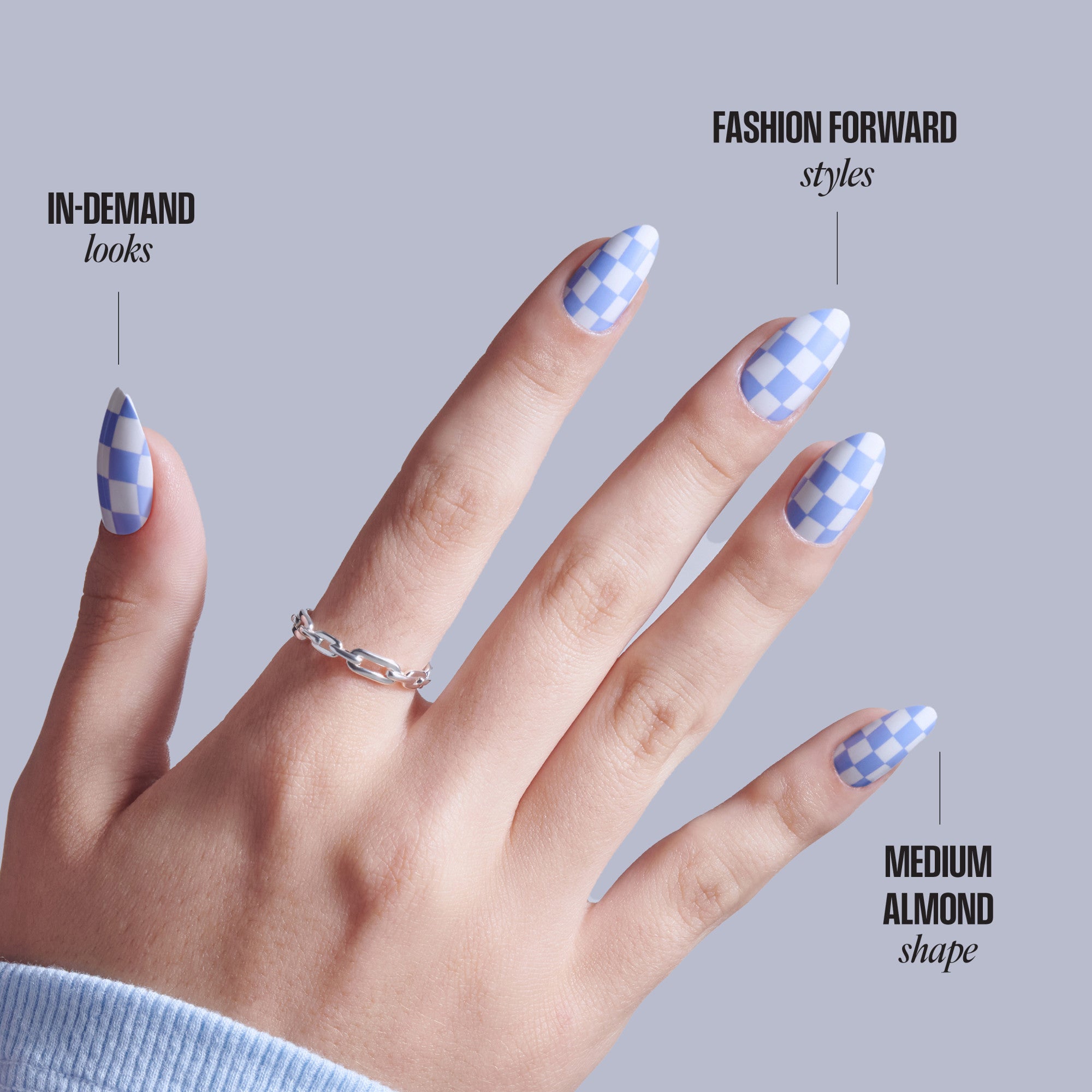 Blue and white checkered nail design on medium almond-shaped nails with silver ring.