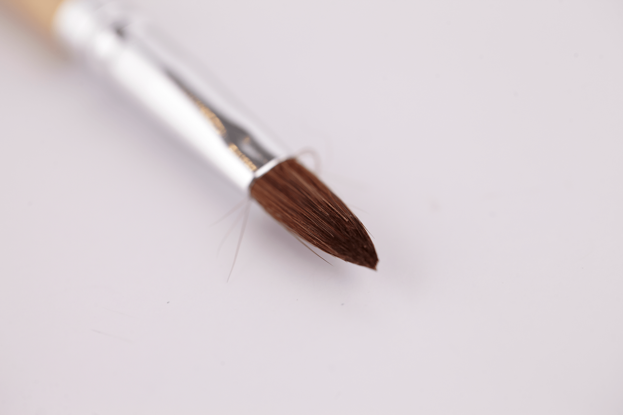 Fine-tipped brush with brown bristles and a silver ferrule, shown against a plain light background, part of the KISS Acrylic Fill Kit.