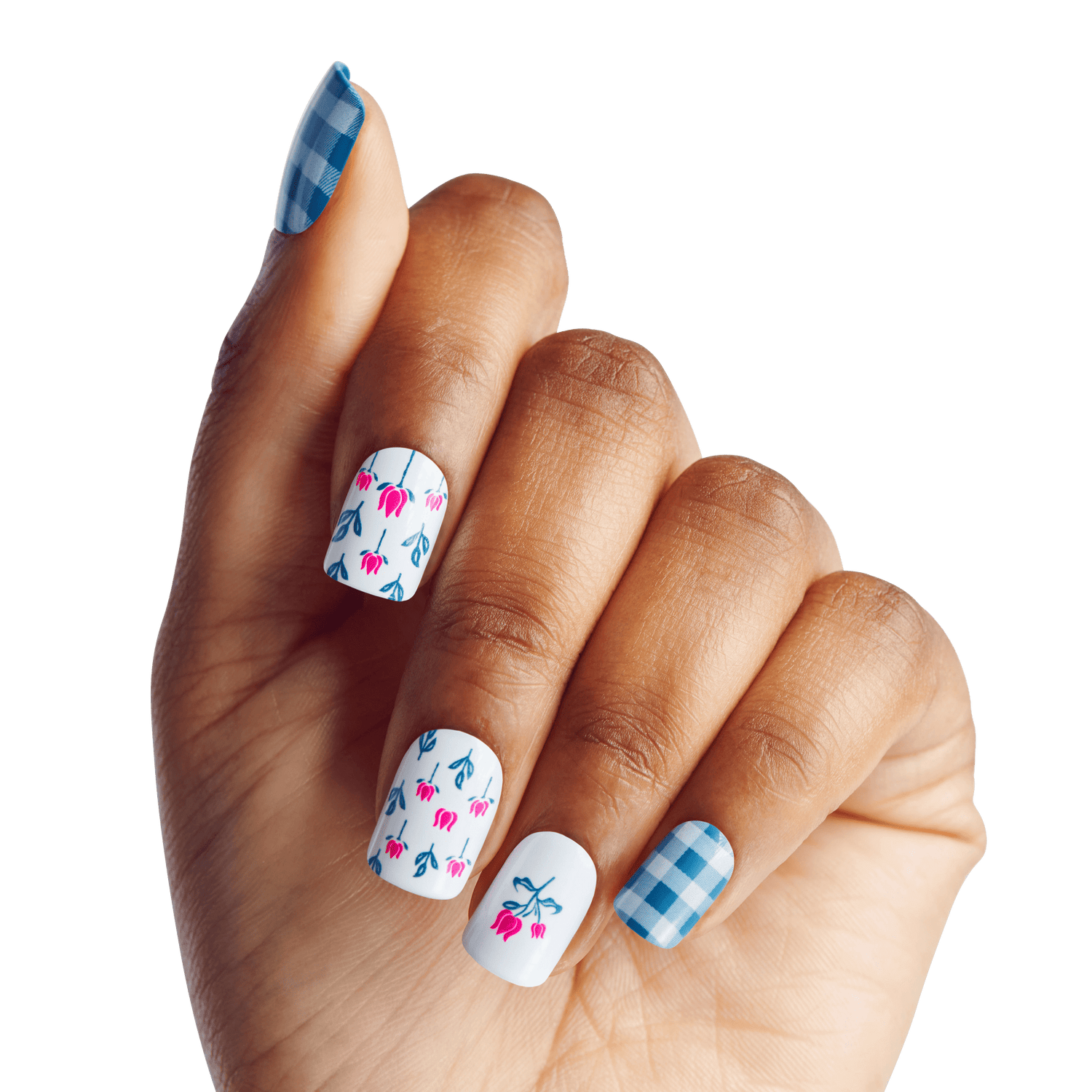 Hand with nails painted in a WICKED X KISS Marvelous Munchkinland design, featuring blue gingham pattern on pinky and thumb, and white background with small blue and pink floral motifs on middle three nails.