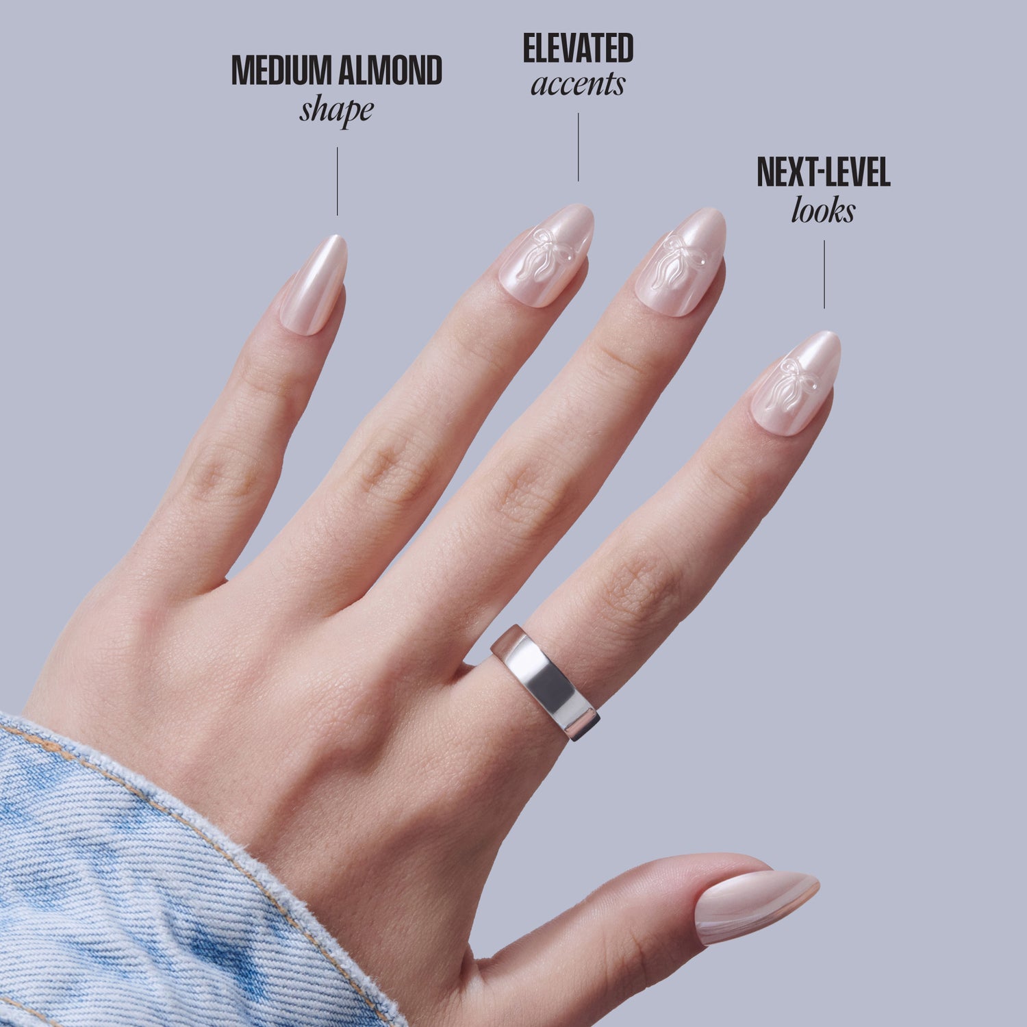 Hand displaying medium almond nails with elevated accent designs and next-level looks.