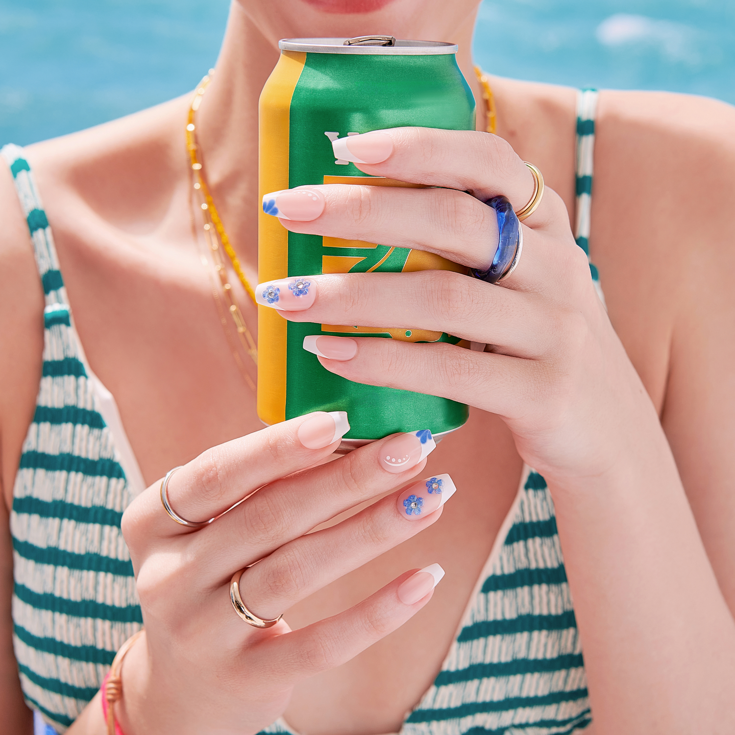 Person holding a green and yellow can with a blue background