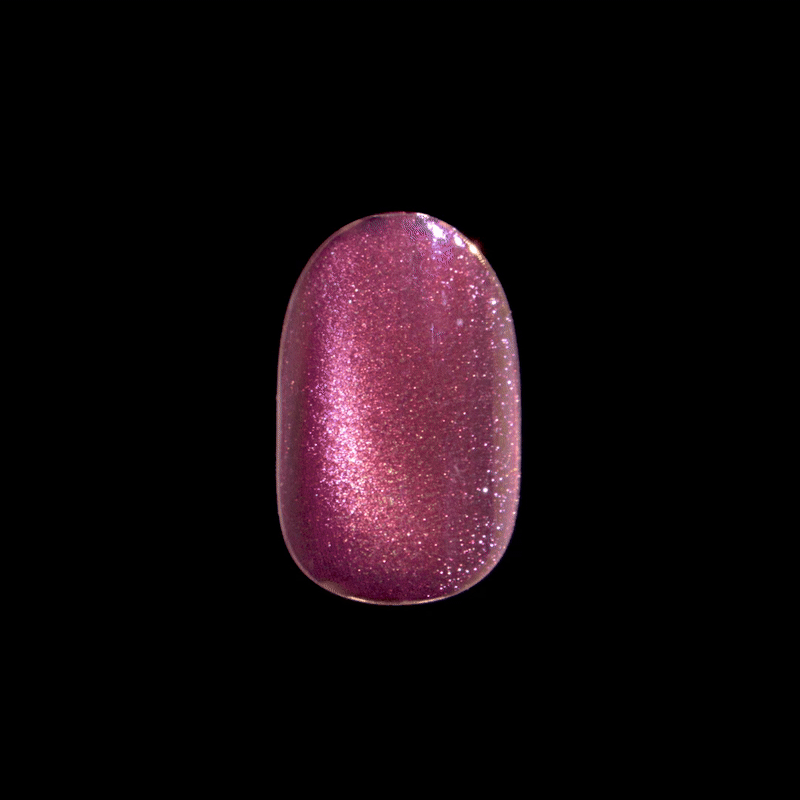 Shimmering press-on nail with a rounded shape in a deep pink color featuring fine glitter and a glossy finish against a black background.