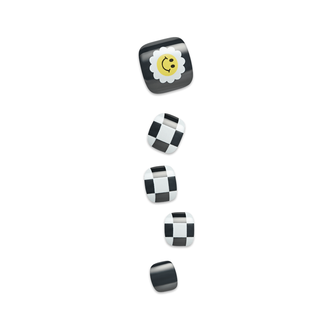 Five press-on toenails in black and white designs, featuring a smiling yellow daisy on the largest nail and black-and-white checkered patterns on the others.