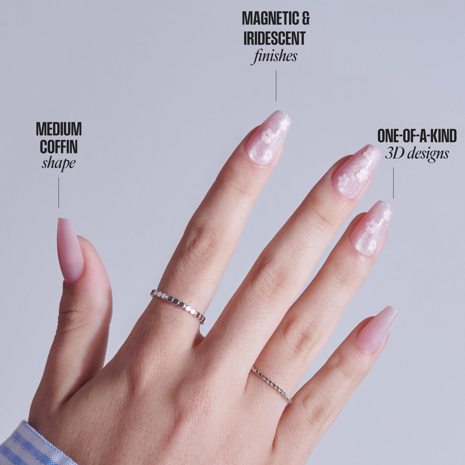 Hand displaying nails: coffin shape, magnetic iridescent finish, 3D designs, with silver rings.