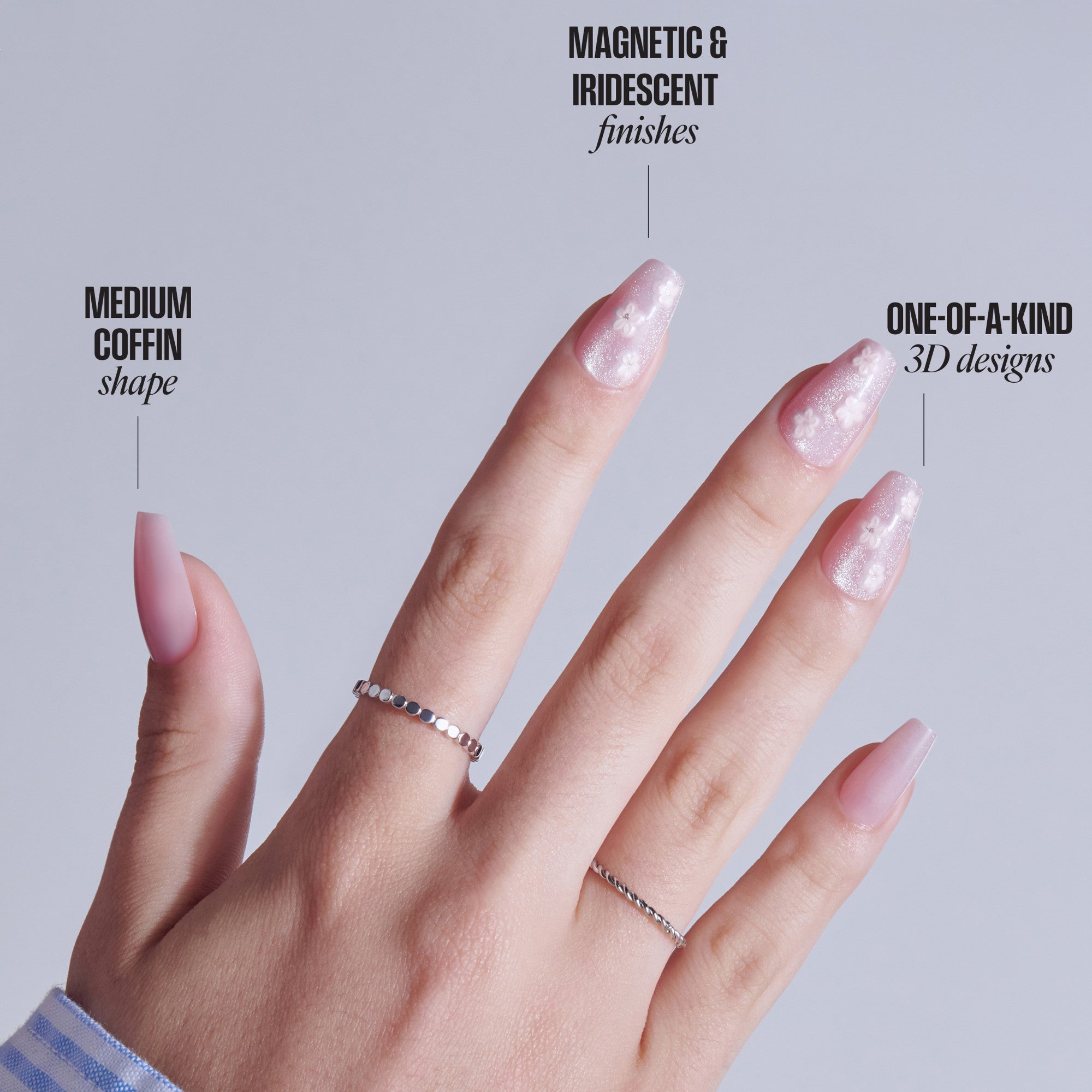 Hand displaying nails: coffin shape, magnetic iridescent finish, 3D designs, with silver rings.