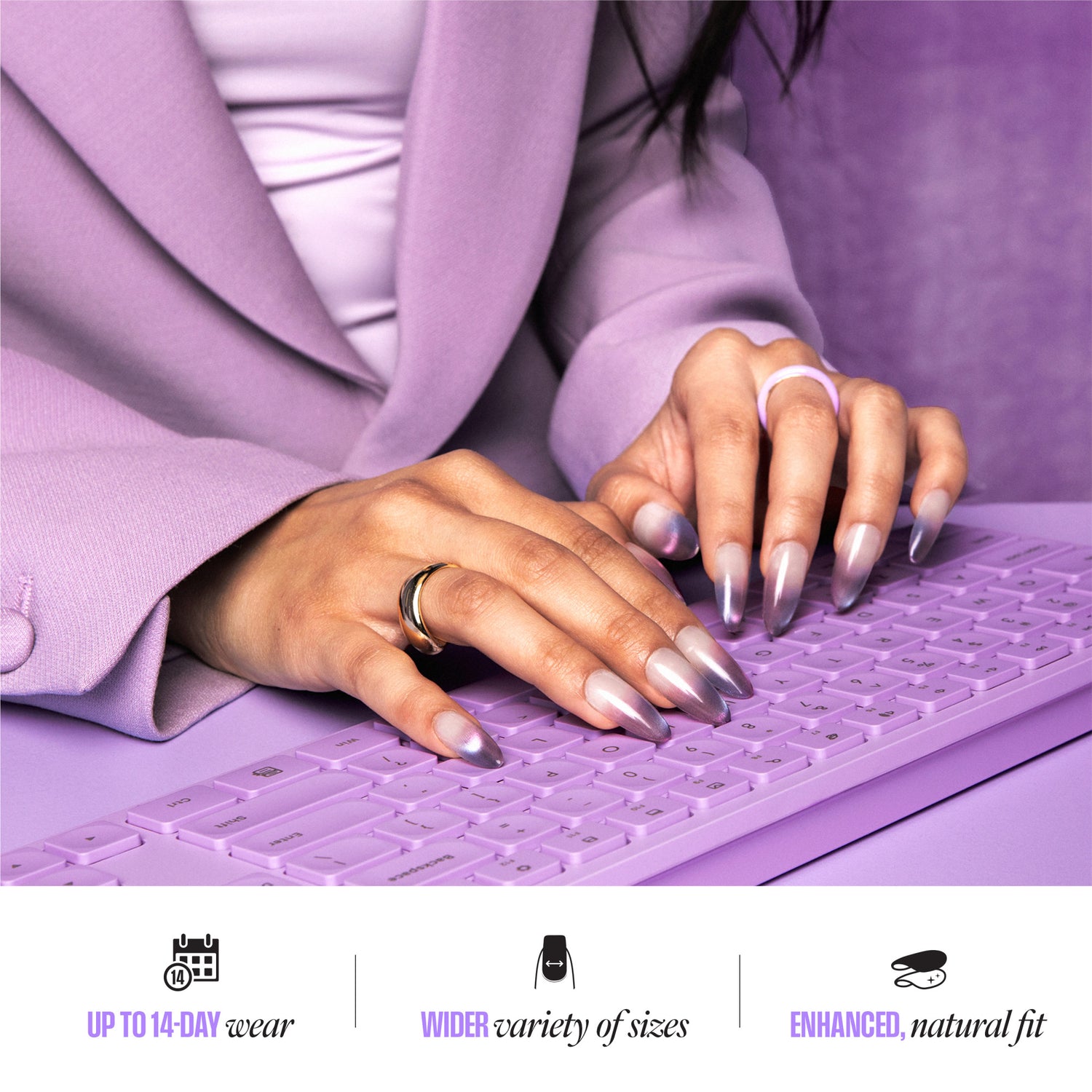 Hands typing on purple keyboard, wearing metallic nails and ring. "Up to 14-day wear" text below.