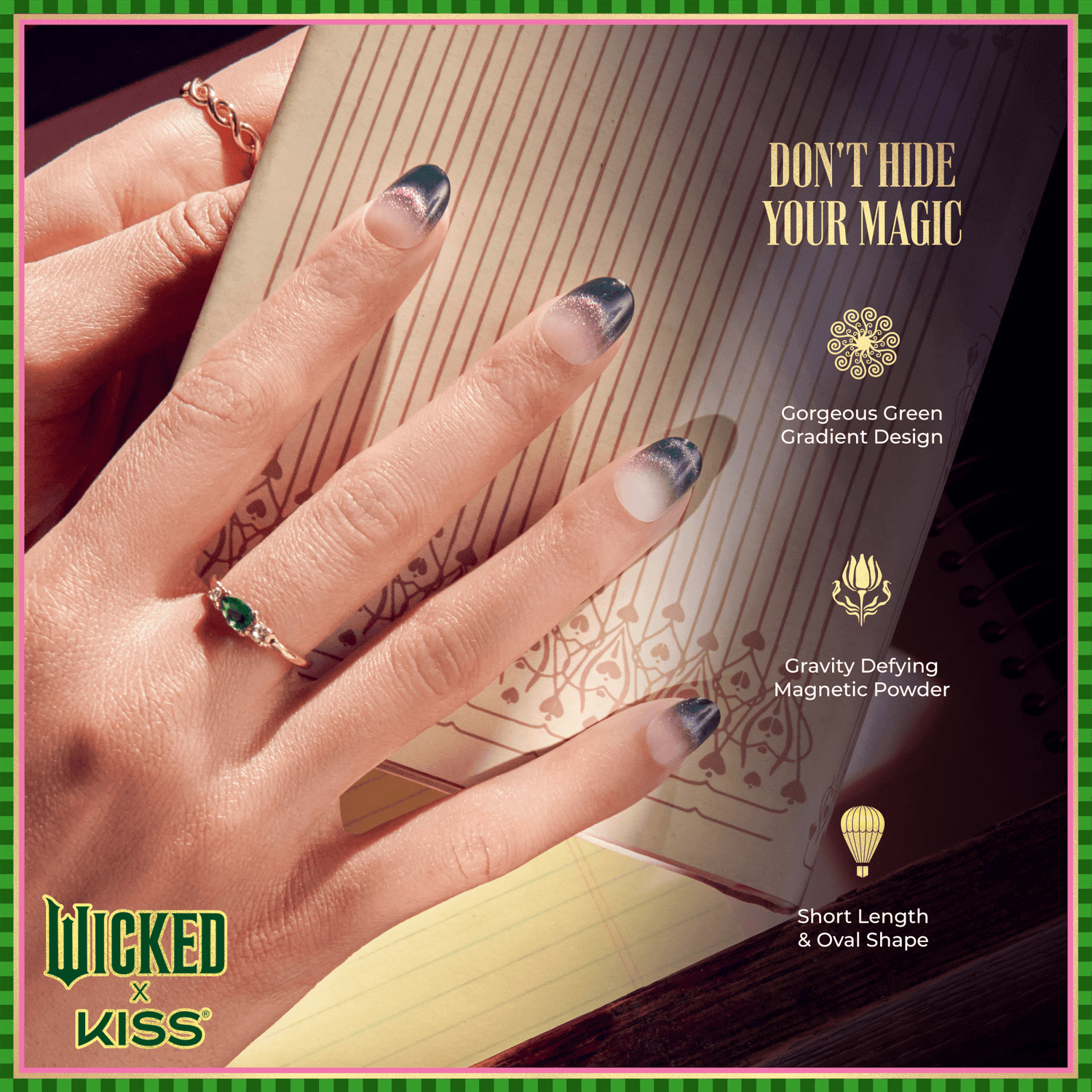 Hand with short oval nails featuring a green gradient magnetic design, wearing gold rings, resting on an open notebook. Text: \