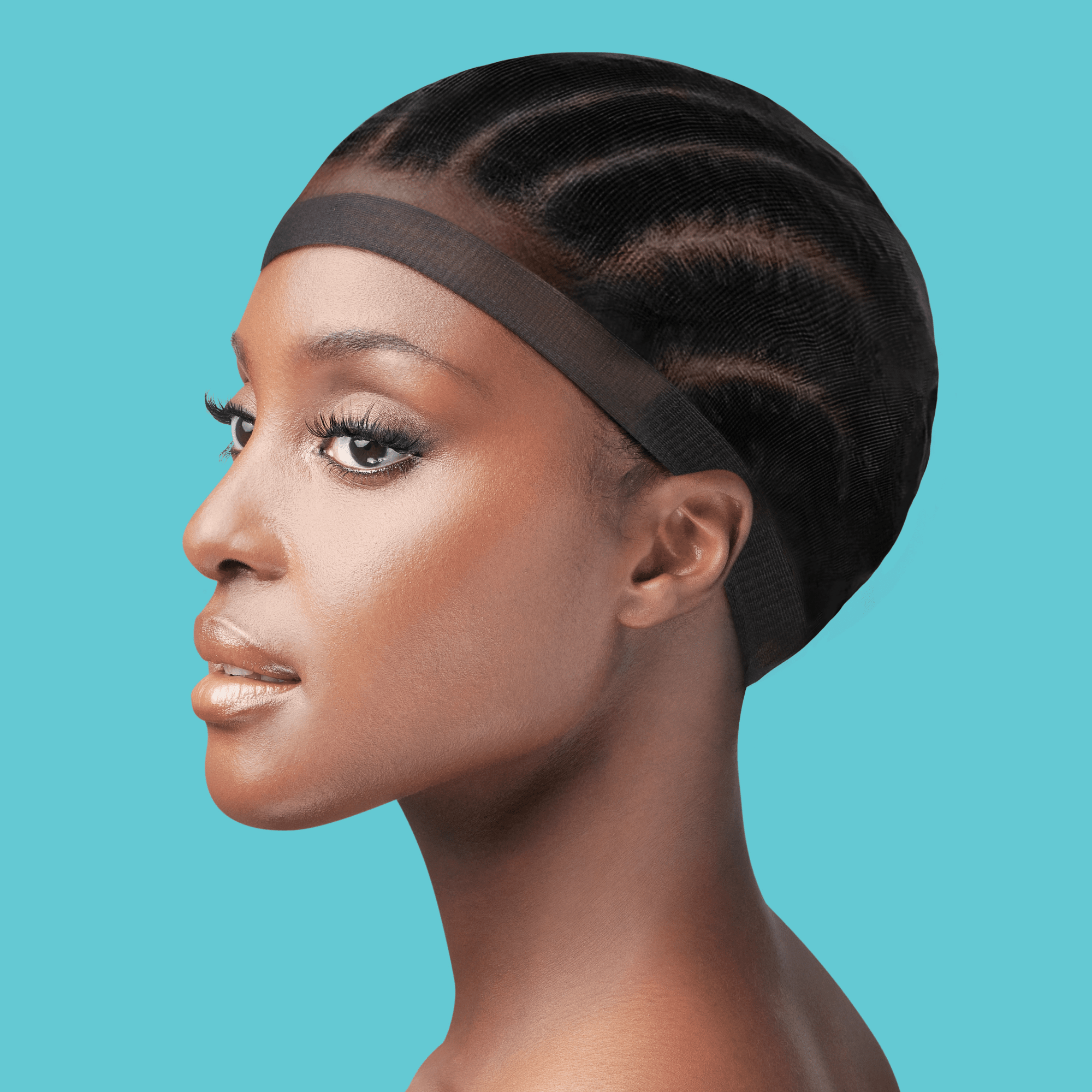 Woman’s side profile wearing a black invisible stocking wig cap over braided hair, neutral makeup, against a solid turquoise background.