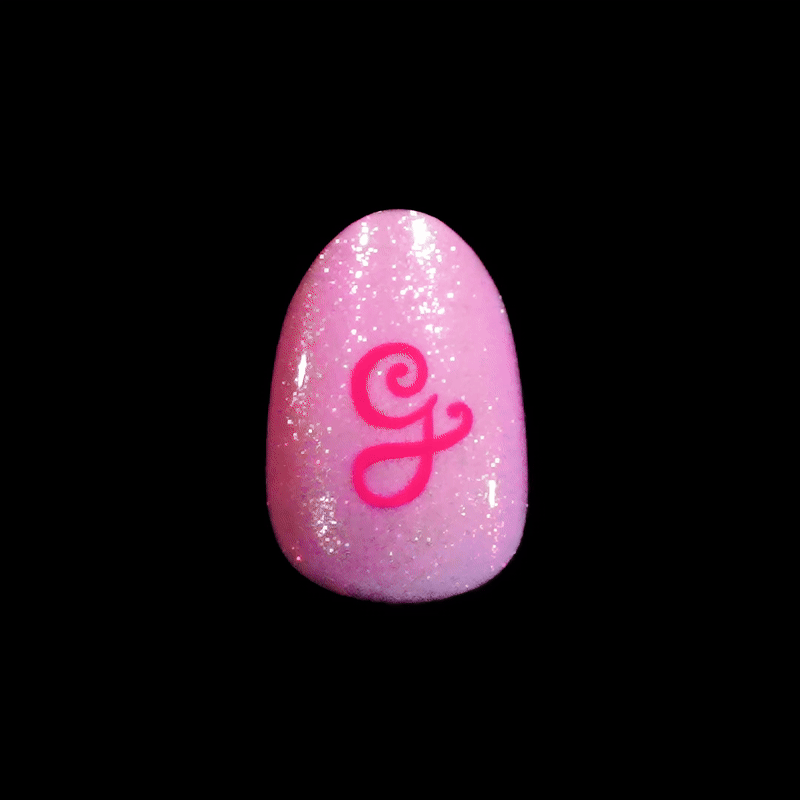Glossy pink artificial nail with fine glitter and a bold, stylized hot pink letter \