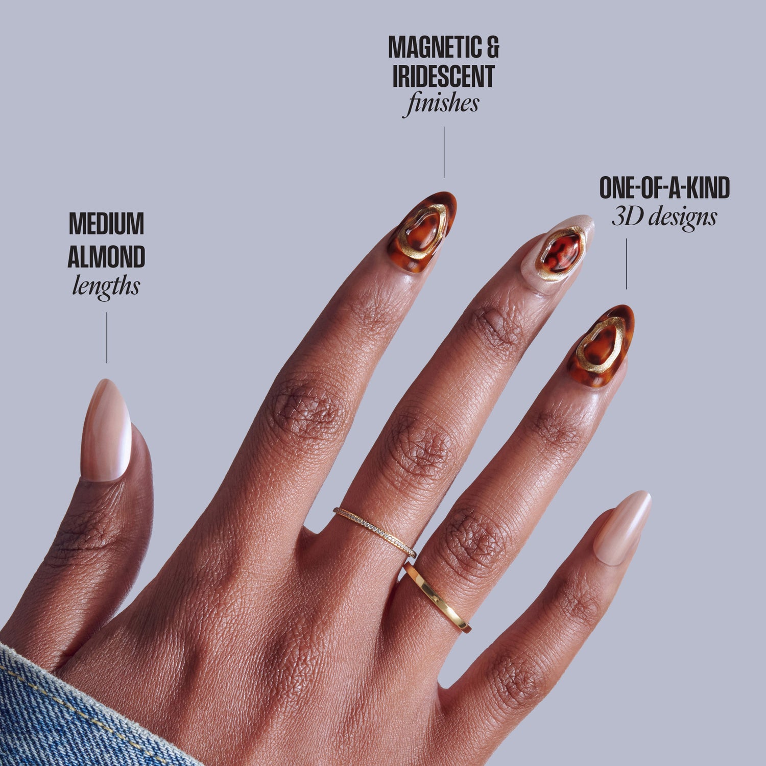 Manicured hand displaying medium almond nails with magnetic iridescent finishes in red-gold 3D designs.