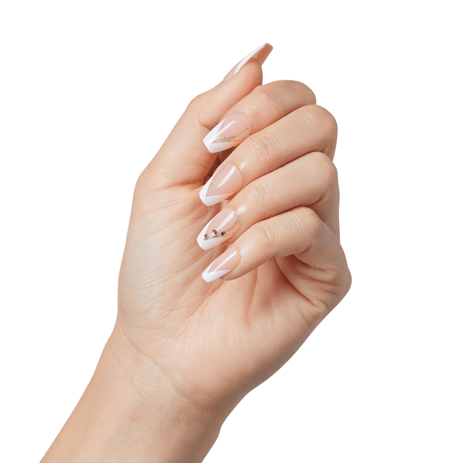 Hand with long, almond-shaped press-on nails in a nude pink base color, white French tip designs, gold glitter accents, and small rhinestones on one nail.