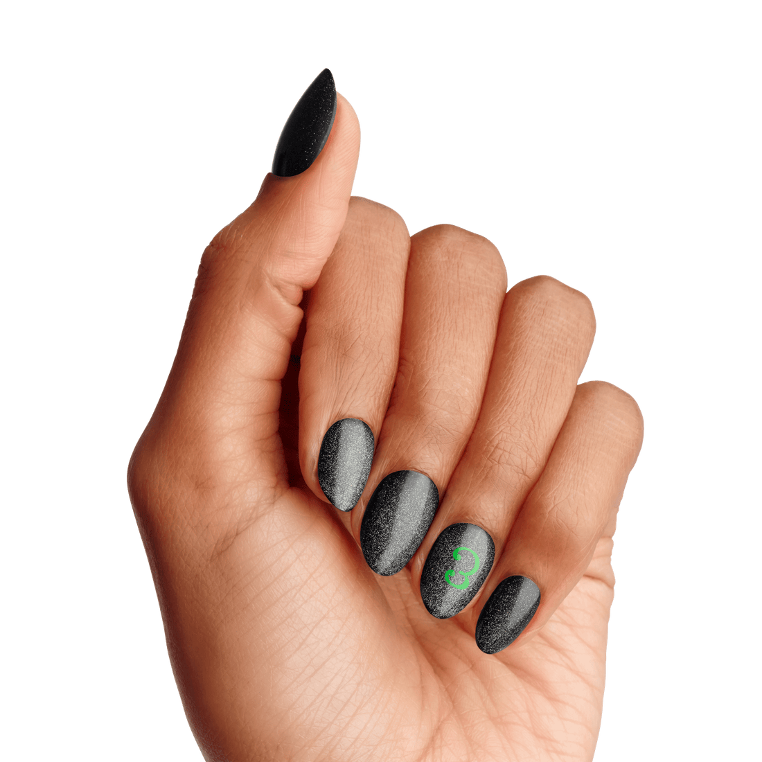 A hand with almond-shaped black matte nails featuring subtle sparkles, with the ring fingernail displaying a small green \