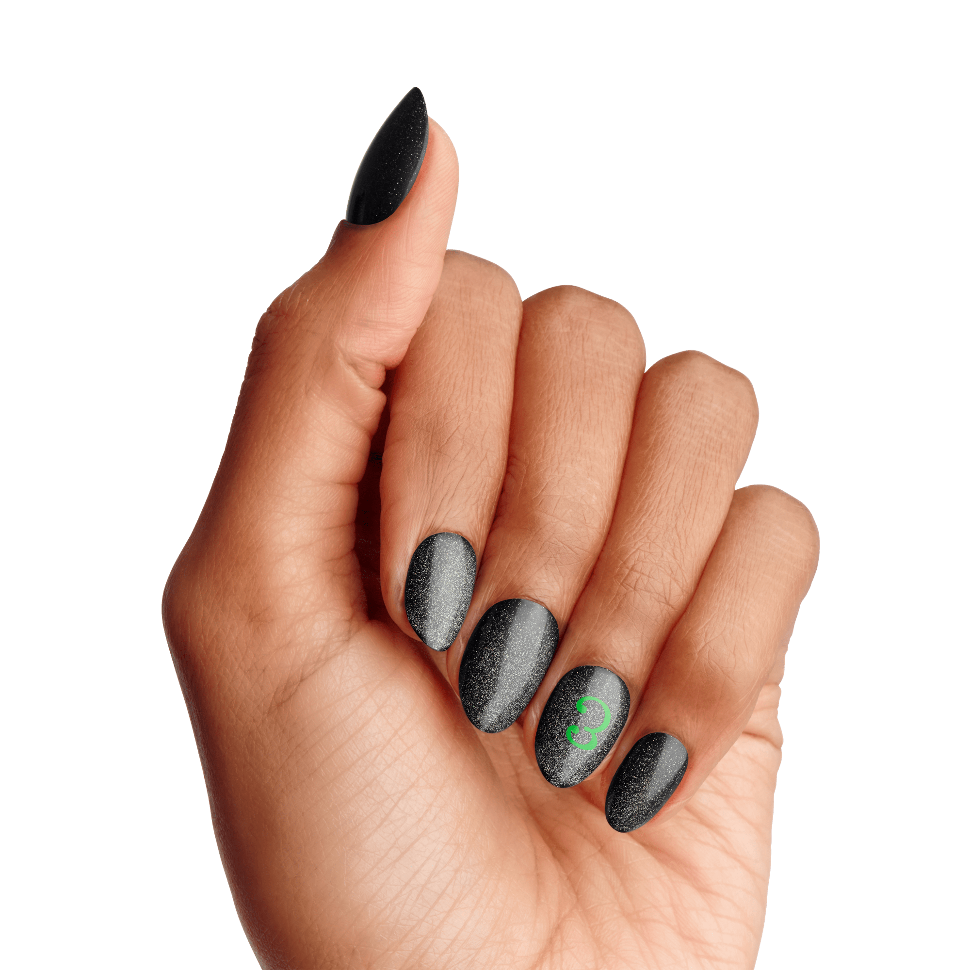A hand with almond-shaped black matte nails featuring subtle sparkles, with the ring fingernail displaying a small green \